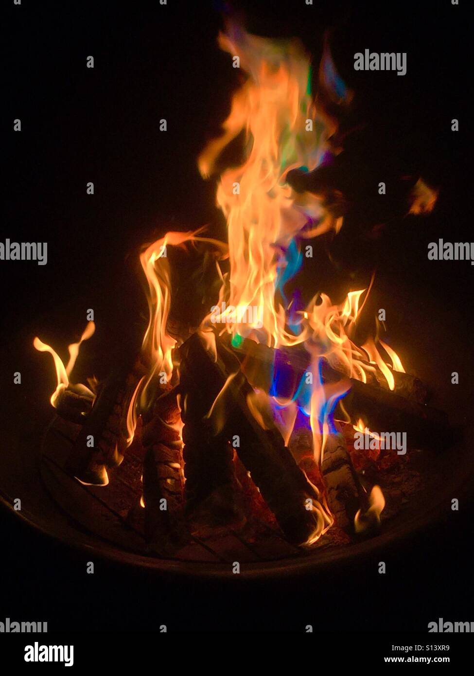 Open wood fire with coloured flames - Smartphone Captured Stock Image