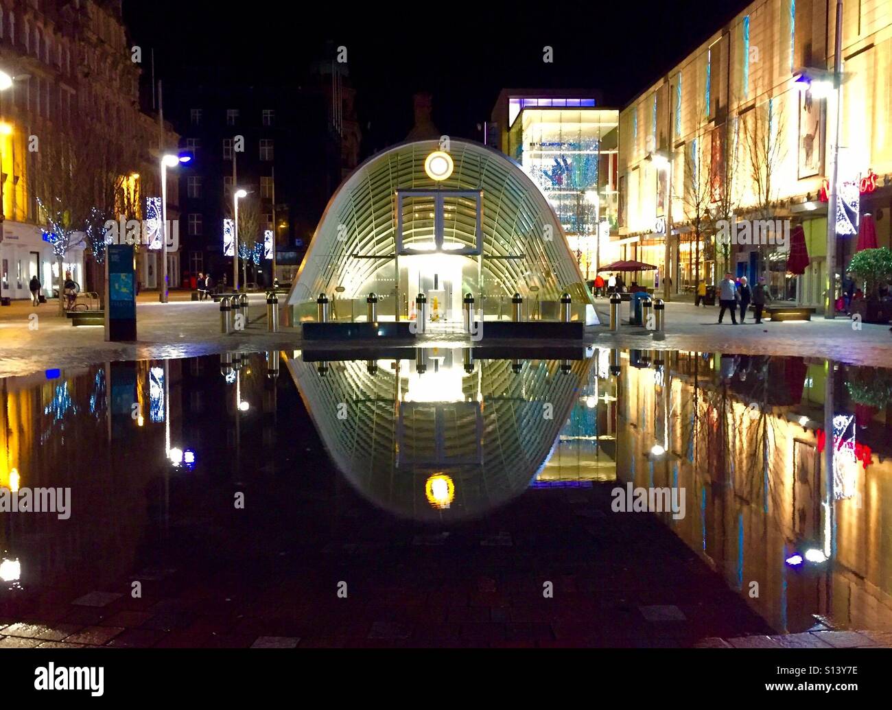 St Enoch Underground station, Glasgow, Scotland reflected in a pool of water at night. - Smartphone Captured Stock Image