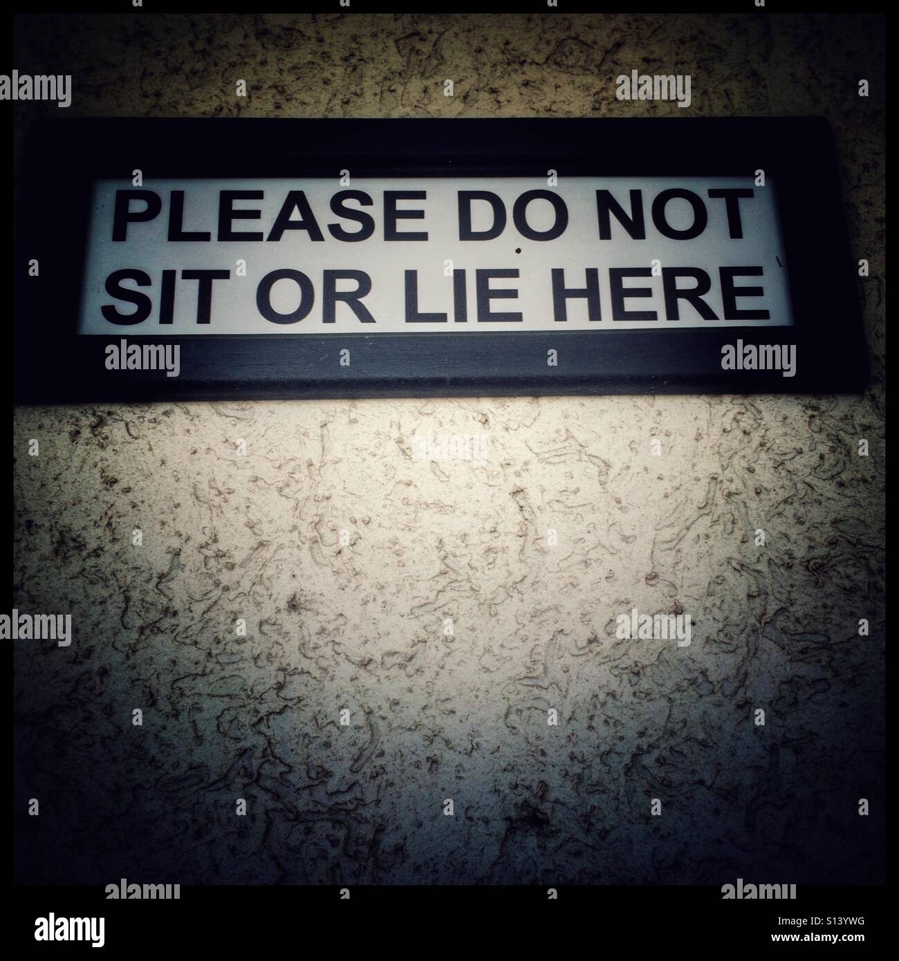 Please do not sit or lie here sign in shopping mall. - Smartphone Captured Stock Image