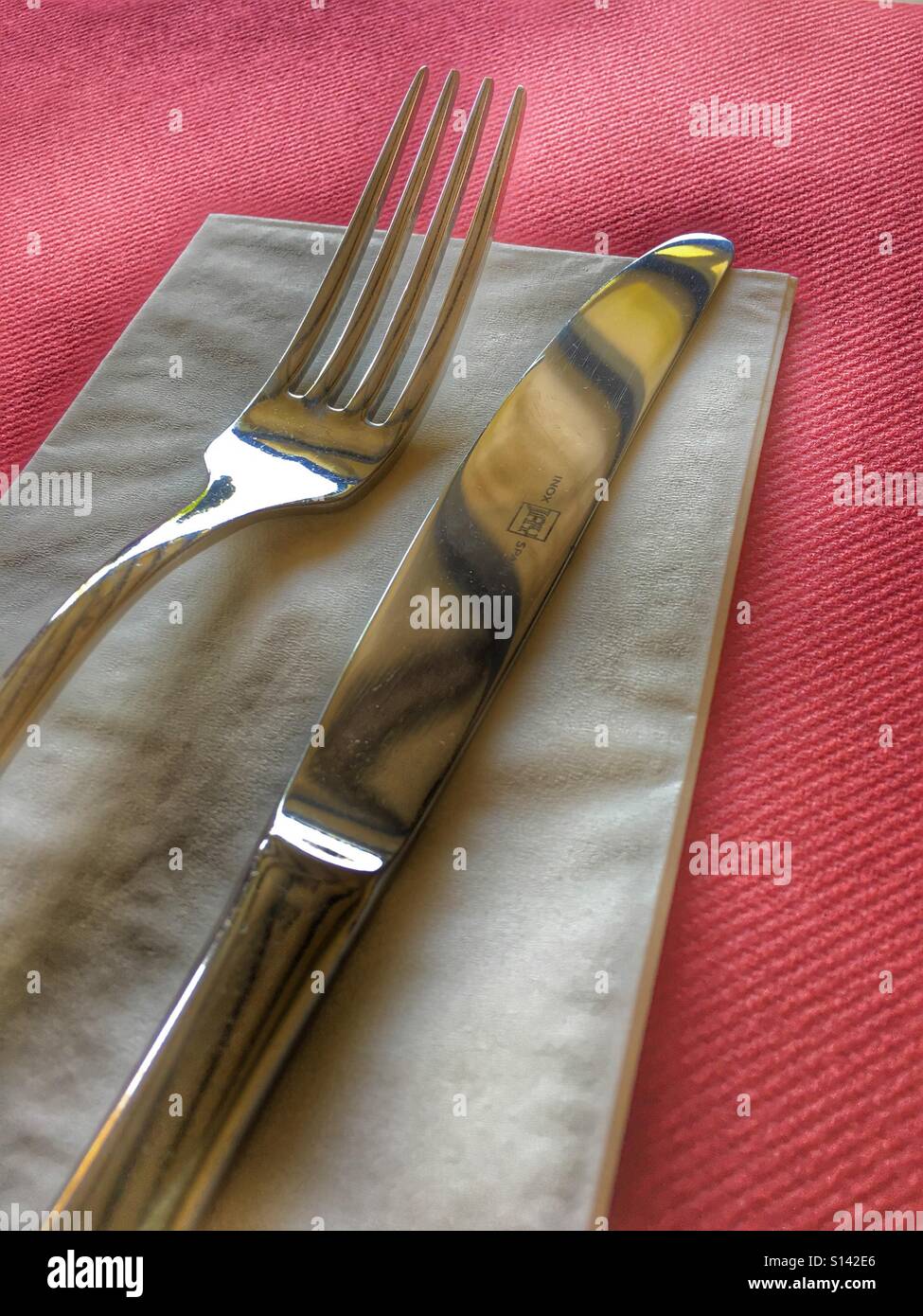 Knife and fork on a serviette. Stock Photo