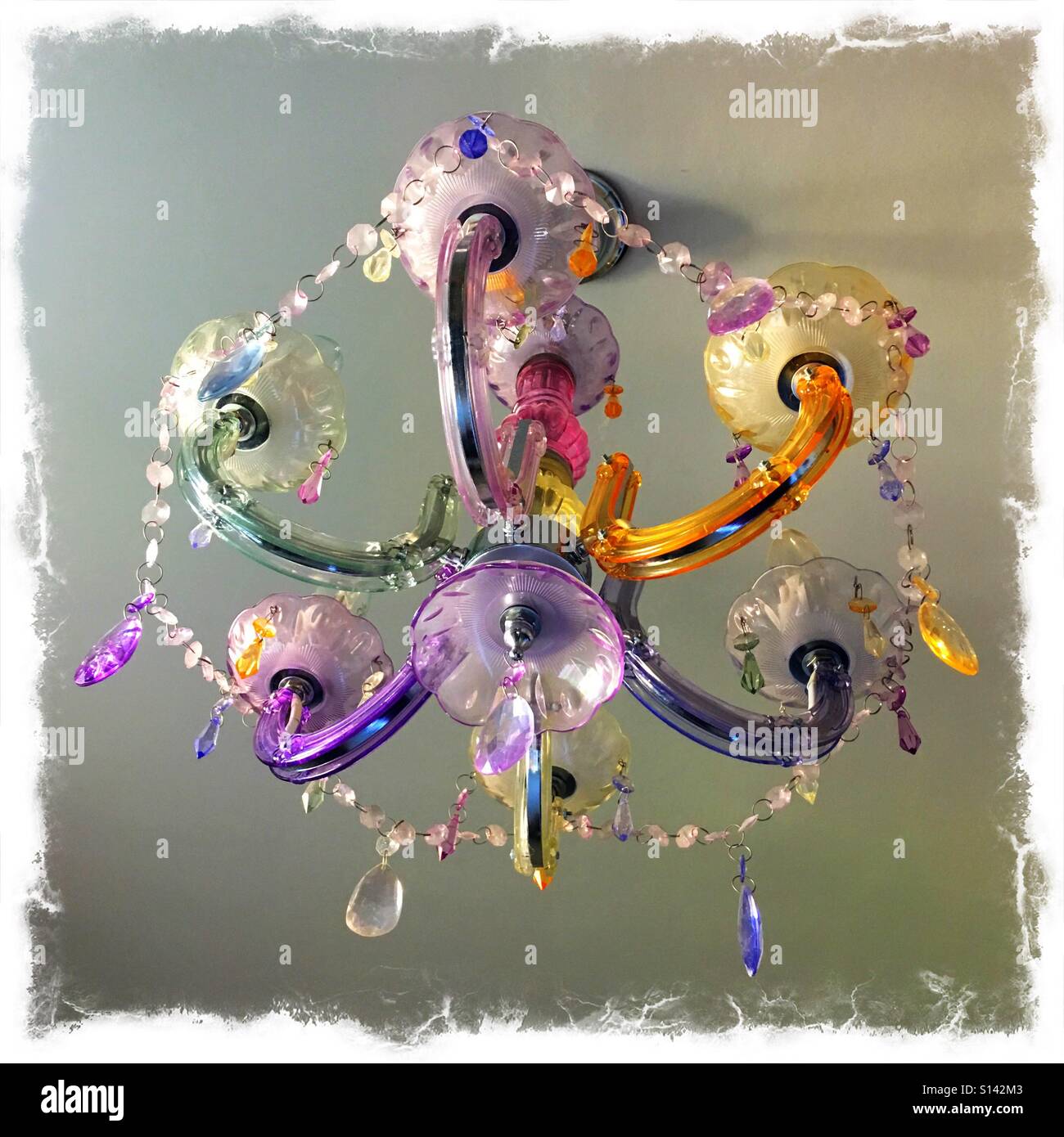 Sparkly multicoloured chandelier hanging from ceiling - Smartphone Captured Stock Image