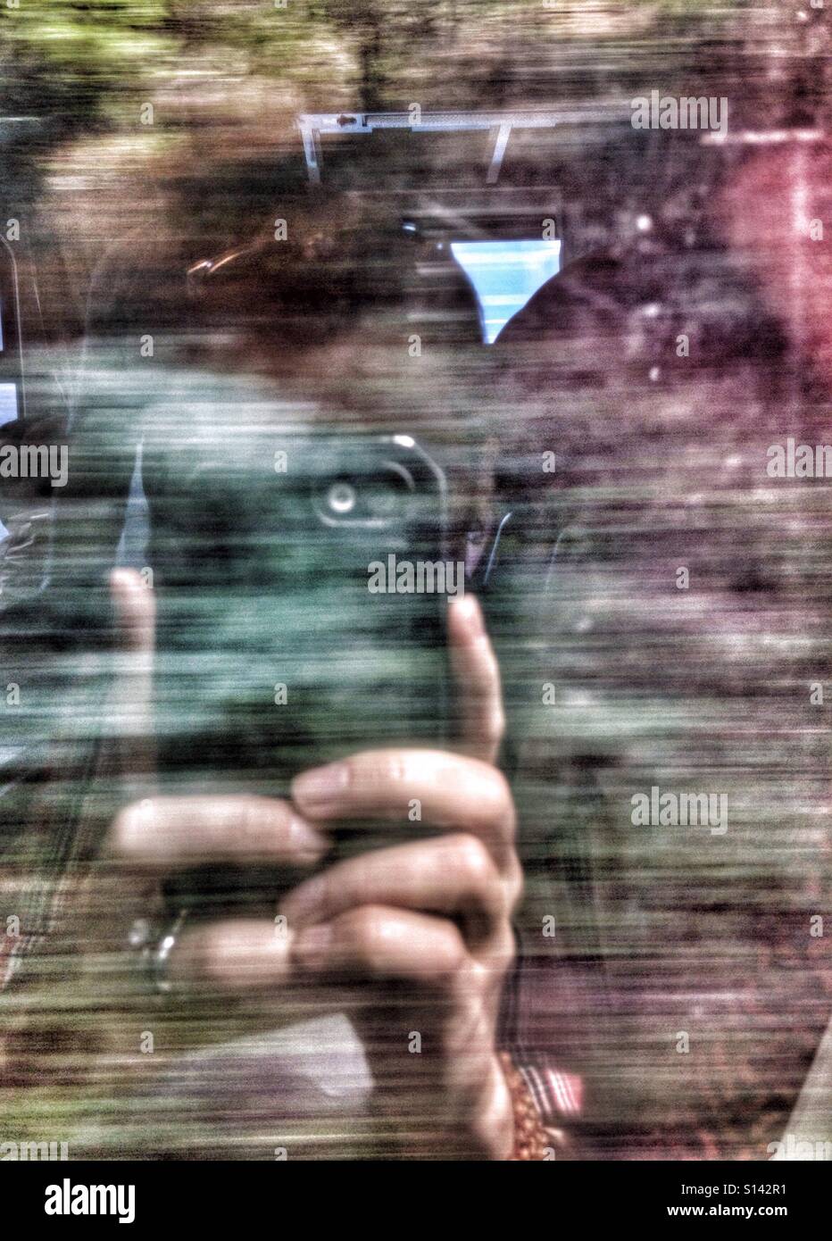 Making selfie reflection picture through glass of moving train - Smartphone Captured Stock Image