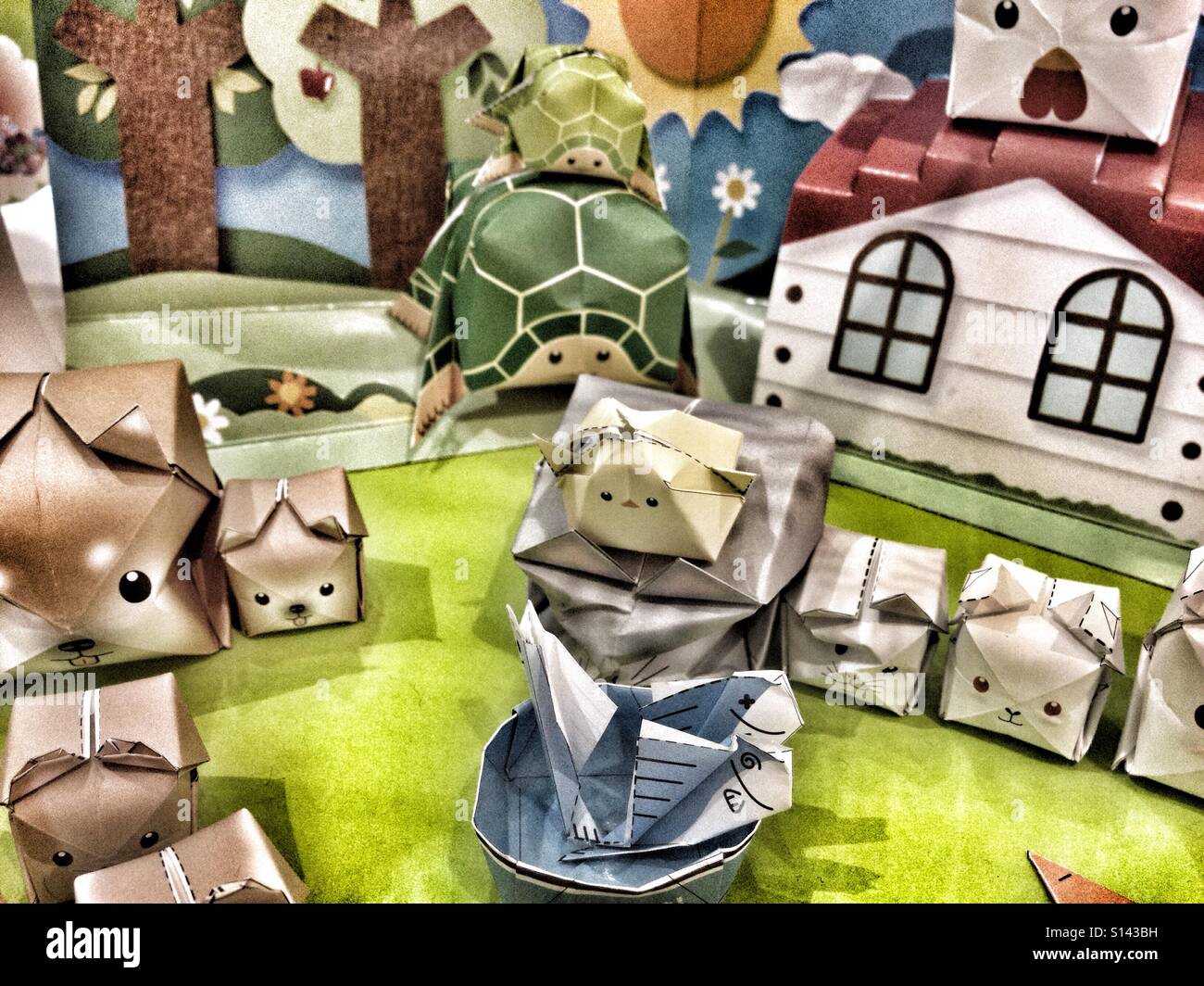 Handmade Origami Animals, Paper Dogs, Cats, Turtles, Chickens - Cube Crafted Origami Trees, House & Background Stock Photo