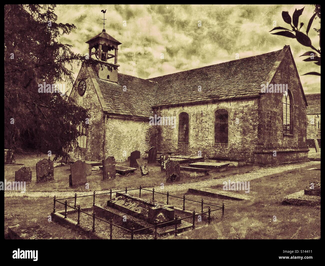 A grunge and antique effect picture of St. Laurence Church in Didmarton, Gloucestershire, England, UK. This building is part of the Church of England & has an unusual Open Bell Tower. © COLIN HOSKINS. - Smartphone Captured Stock Image