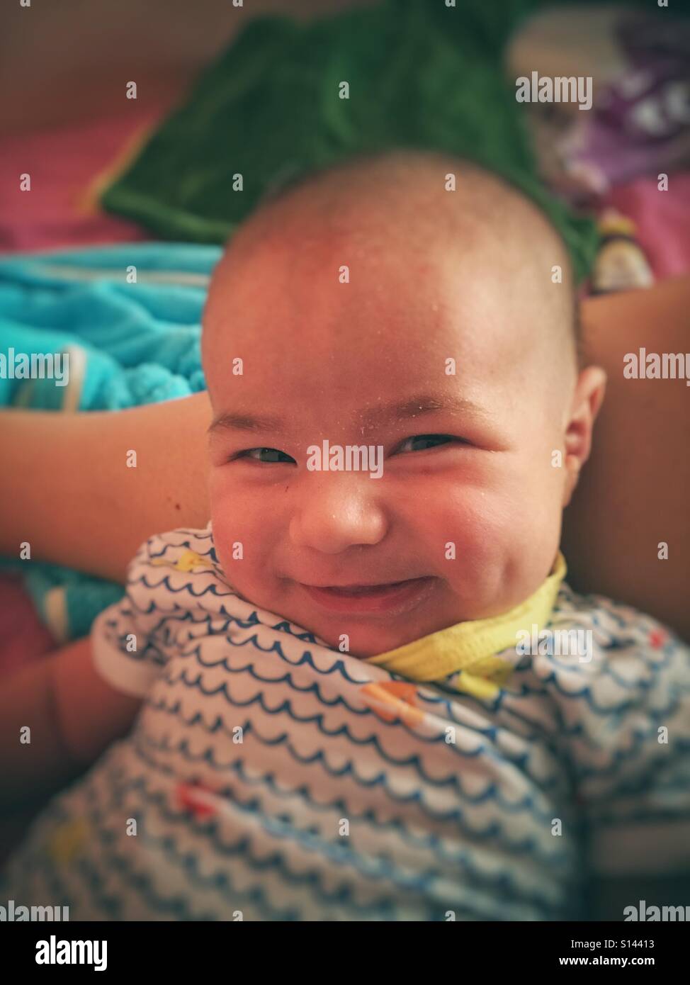 1 month baby looking at the camera and smiling - Smartphone Captured Stock Image
