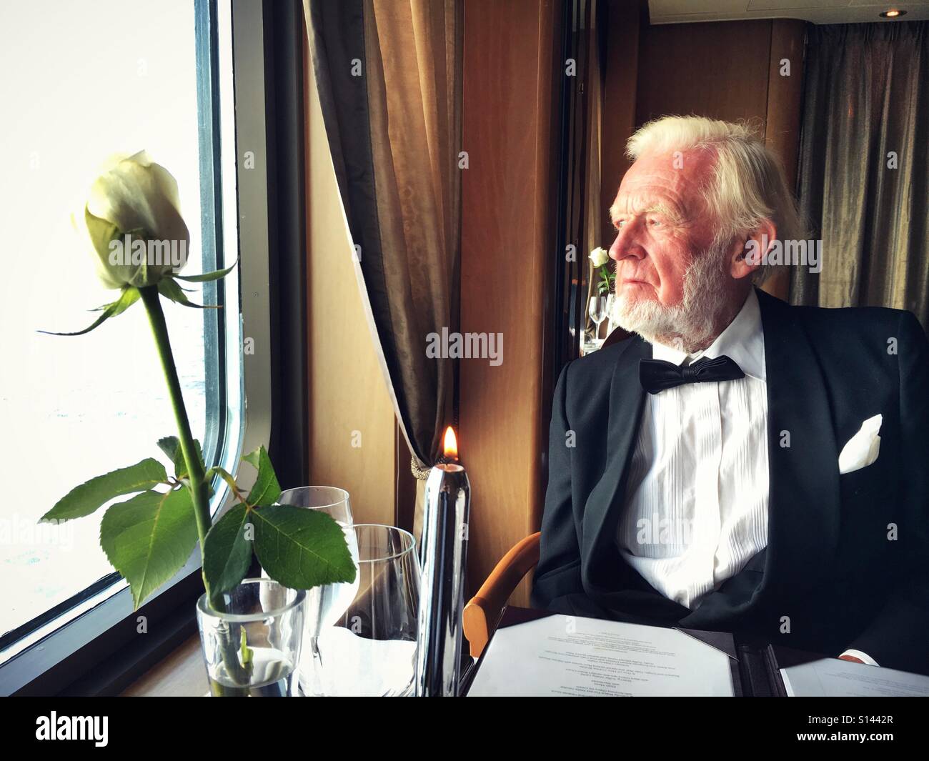 Elderly gentleman dine alone in formal black tie Stock Photo
