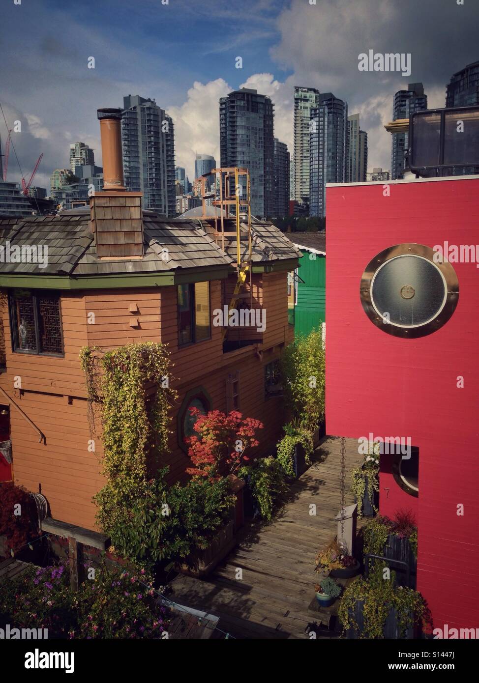 Floating houses at Granville Island, with downtown Vancouver skyline behind (vintage filter added). Vancouver, British Columbia, Canada. - Smartphone Captured Stock Image