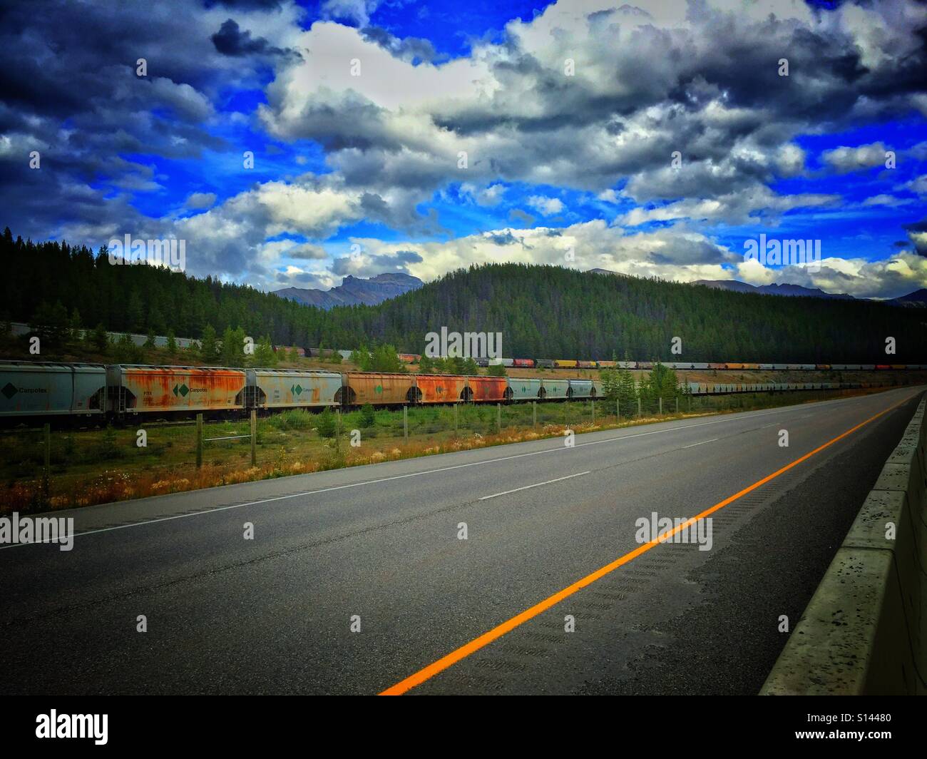 Transcontinental highway and railway tracks Stock Photo