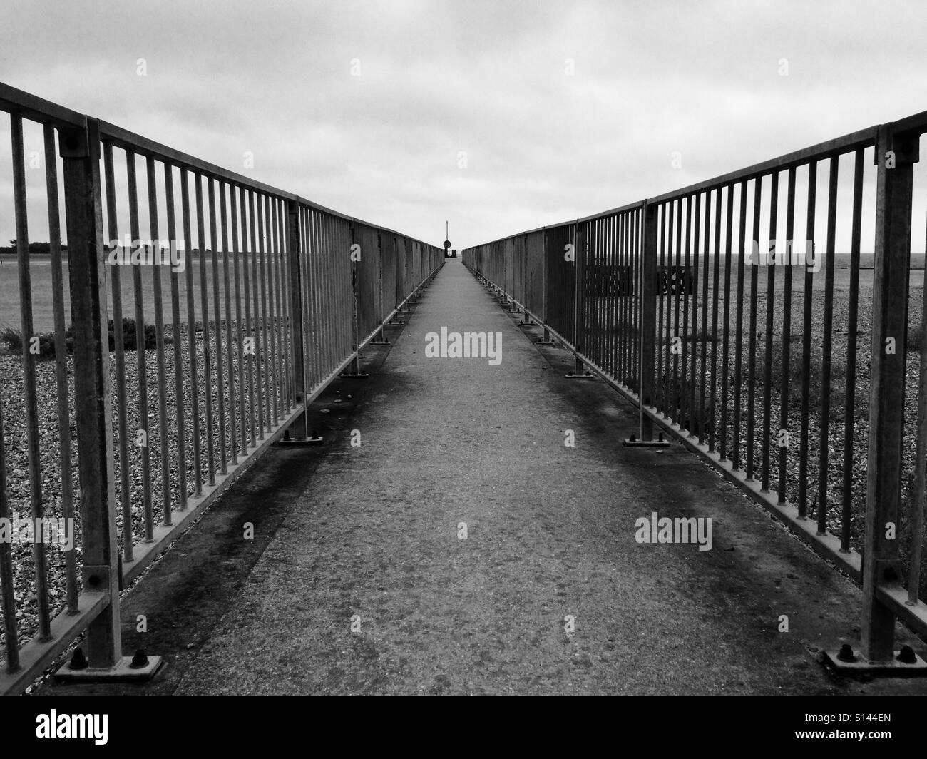 Pathway with railings at the beach in black and white Stock Photo - Alamy