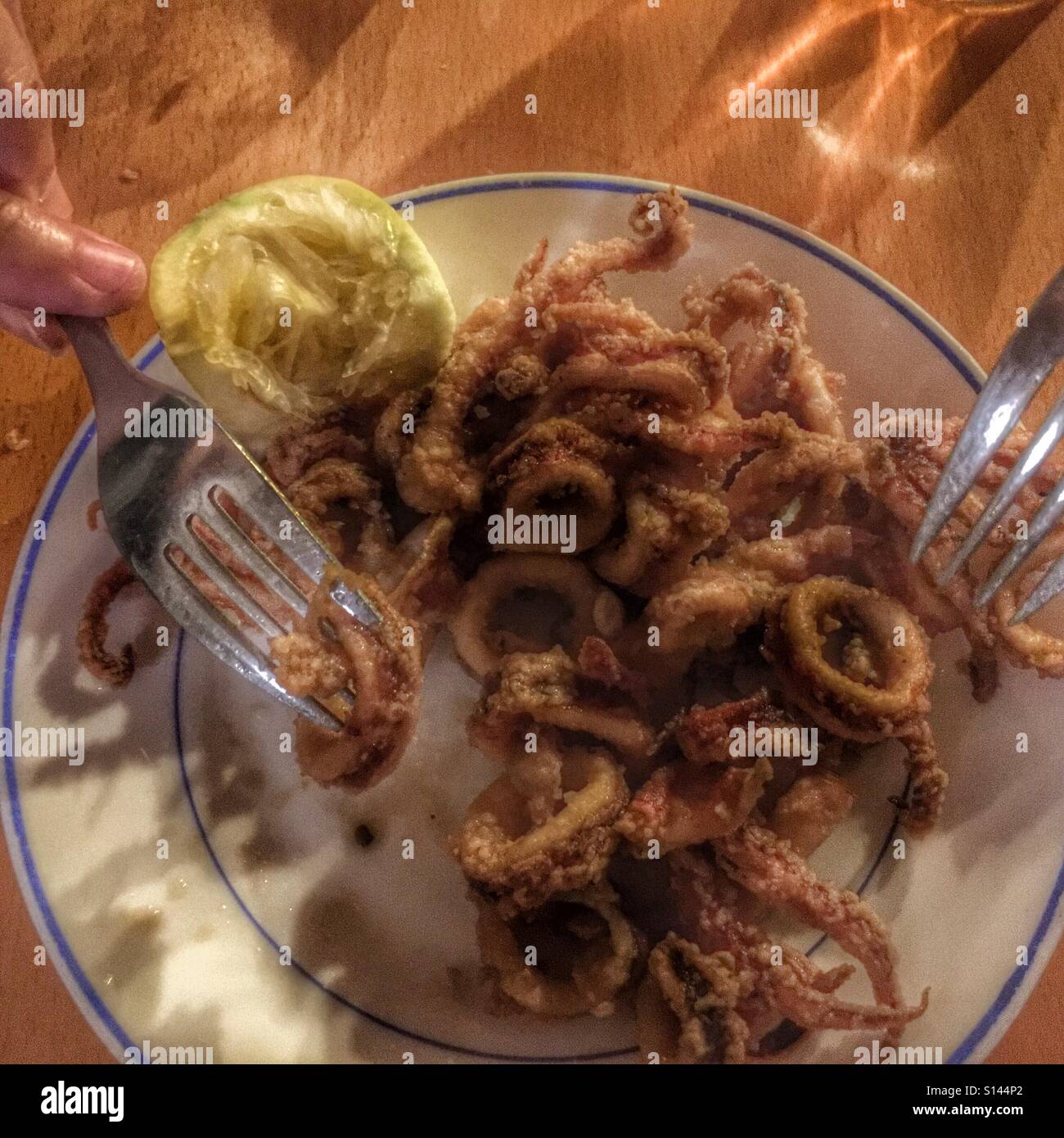 Eating chopitos, a traditional Spanish tapas dish, deep fried baby