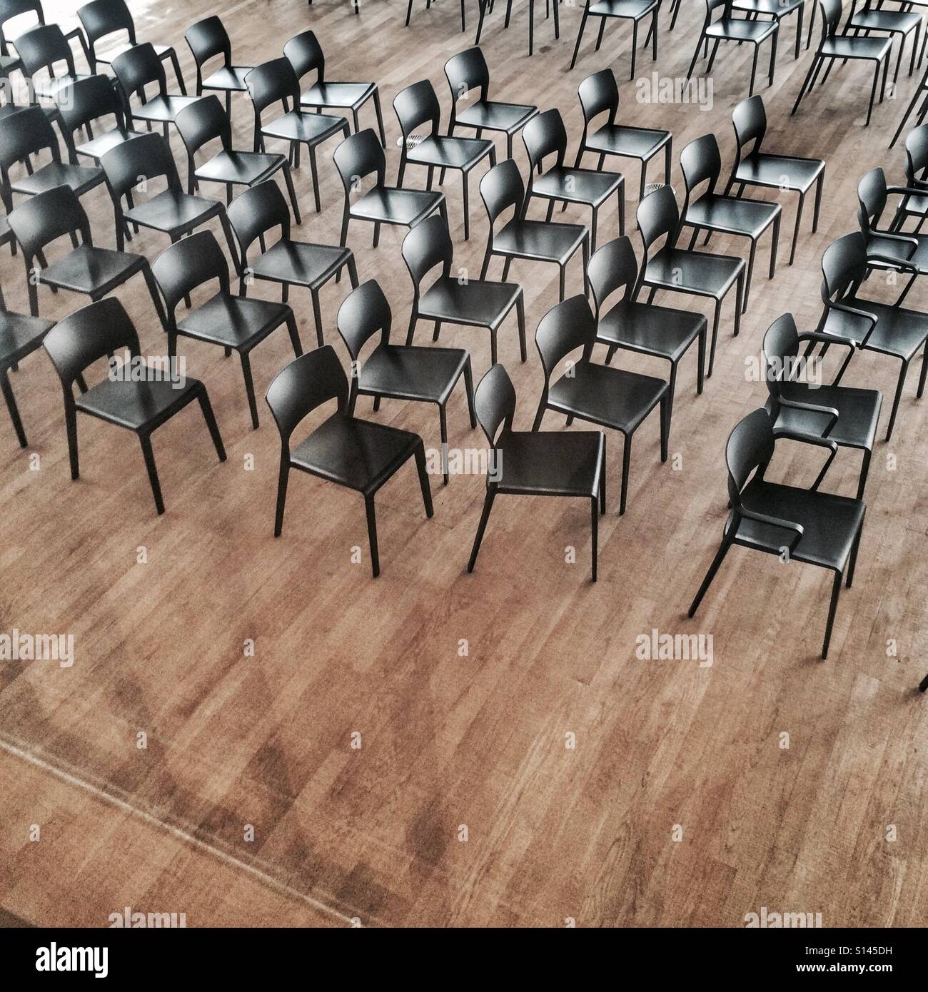 Rows of black chairs Stock Photo