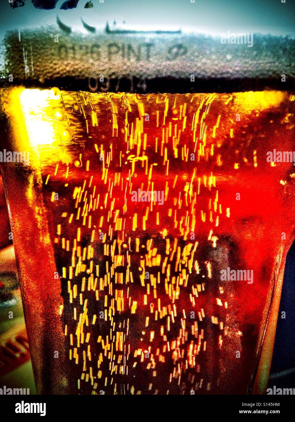 Bubbles in a pint of lager shandy. - Smartphone Captured Stock Image