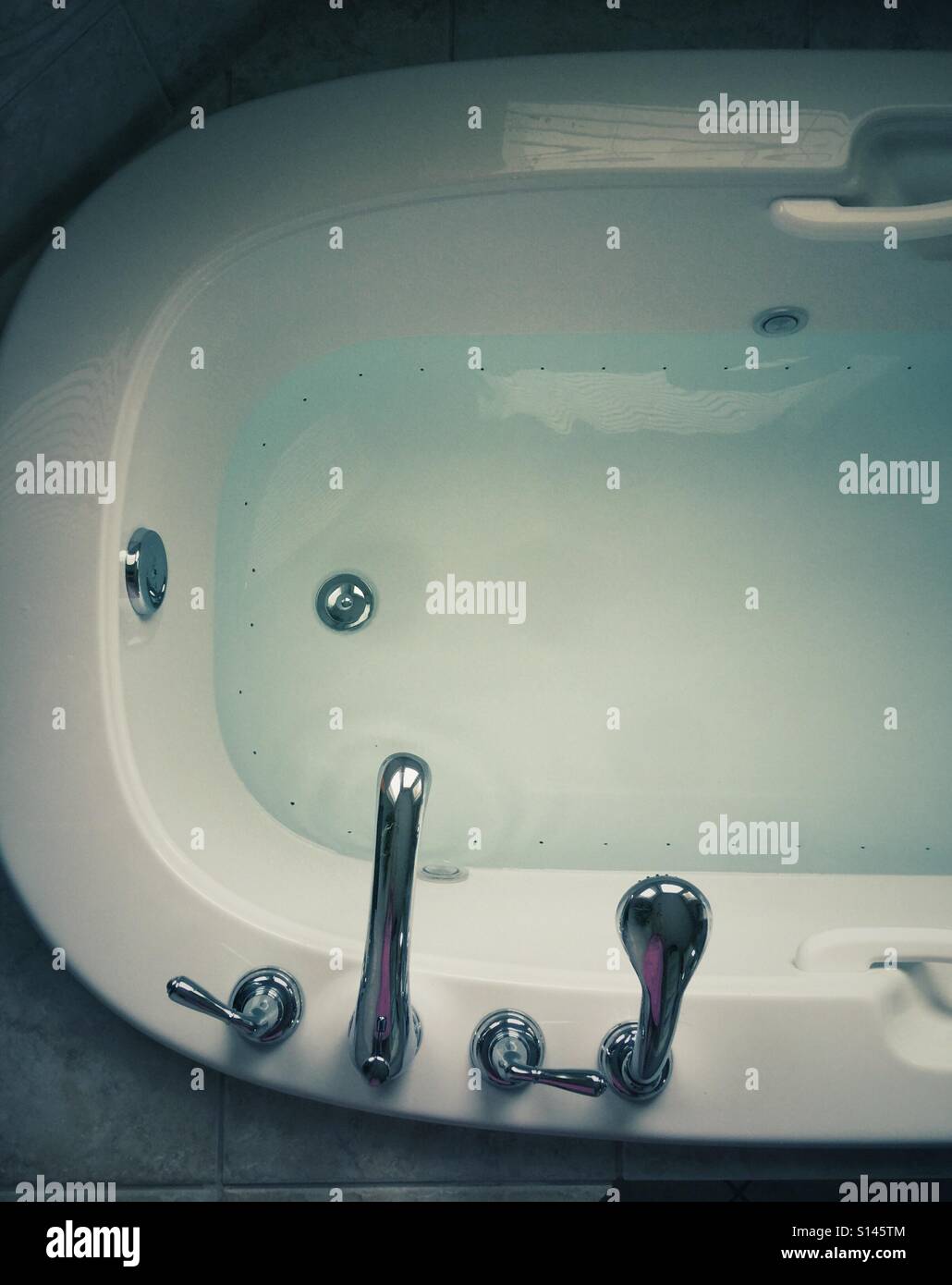 A bathtub with water seen from above. - Smartphone Captured Stock Image