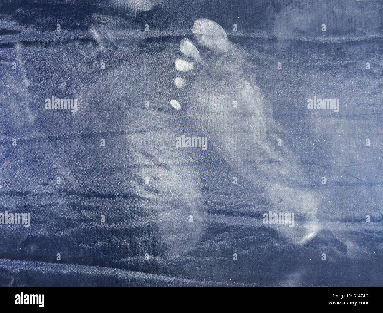 Dusty footprint on dark textile background - Smartphone Captured Stock Image