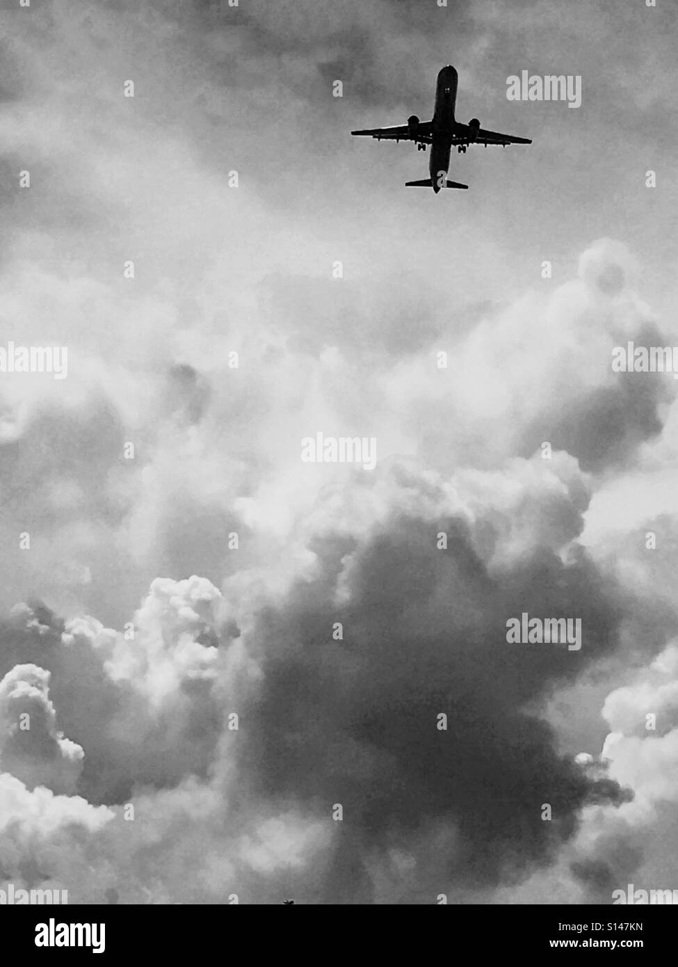 Jet plane amongst the clouds - Smartphone Captured Stock Image