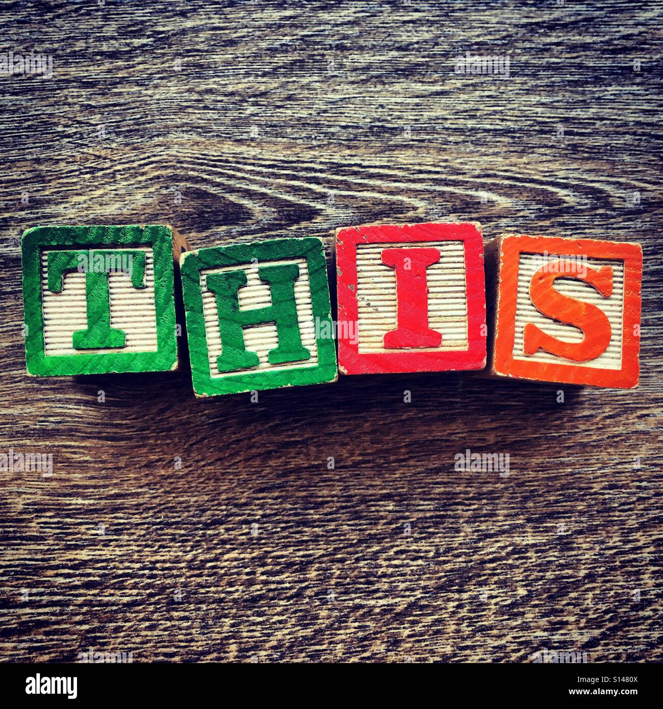 THIS word written with wood block characters Stock Photo Alamy