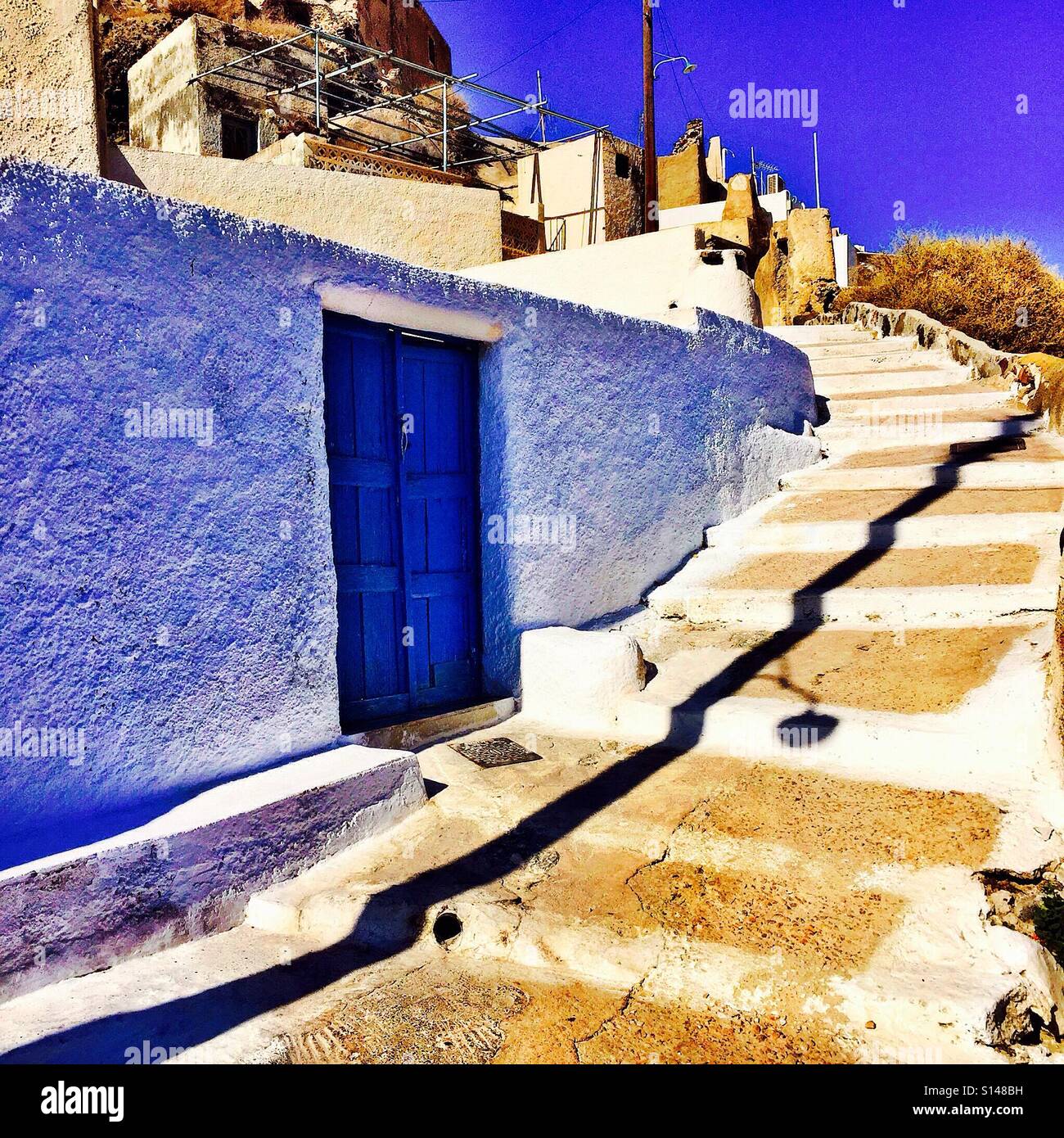 Steps leading up and around a building at Akrotiri on the Greek island of Santorini. - Smartphone Captured Stock Image