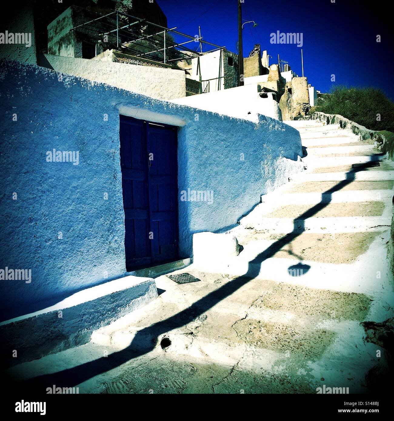 Steps leading up and around a building at Akrotiri on the Greek island of Santorini. - Smartphone Captured Stock Image