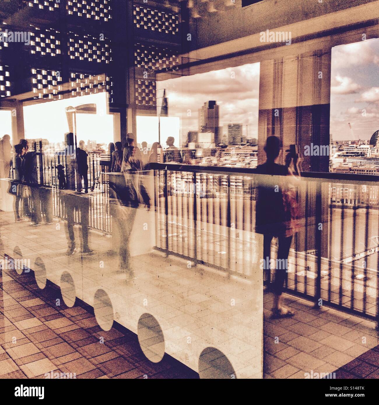 The London skyline and reflections at the viewing Tate Modern extension viewing floor on the Southbank London UK 2016 Stock Photo