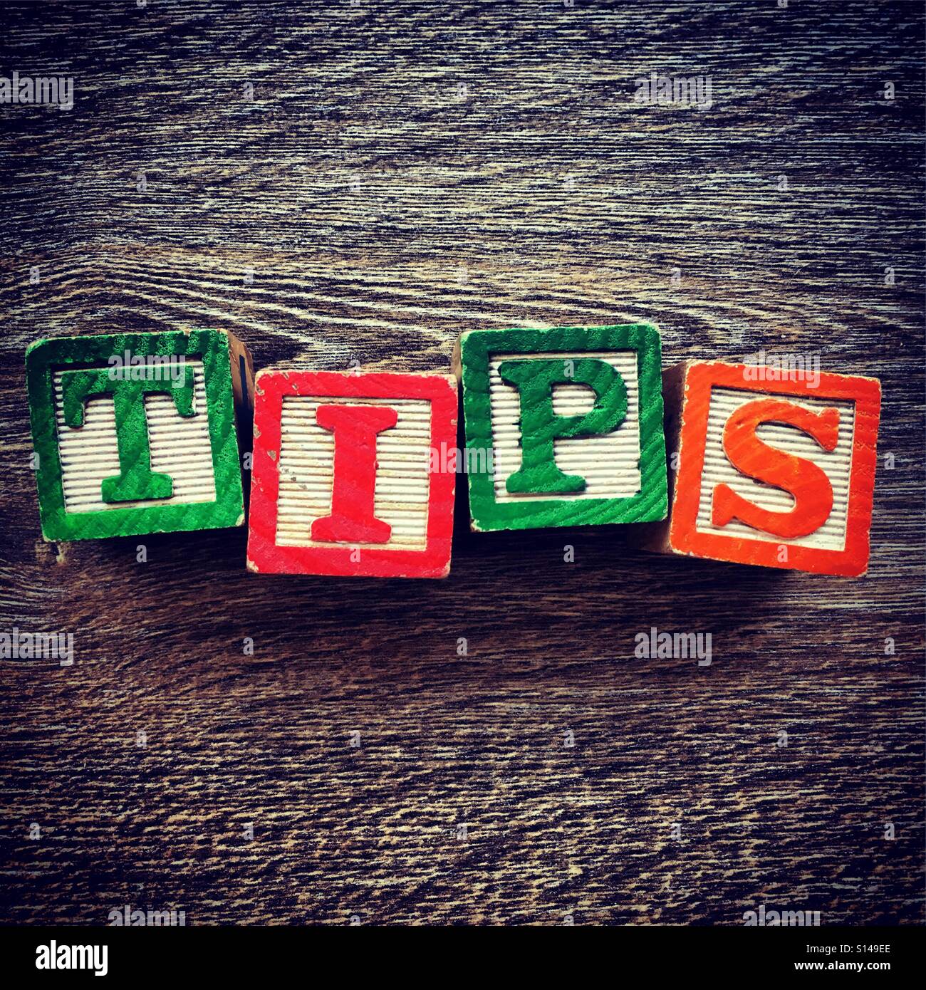 TIPS word written with wood block characters - Smartphone Captured Stock Image