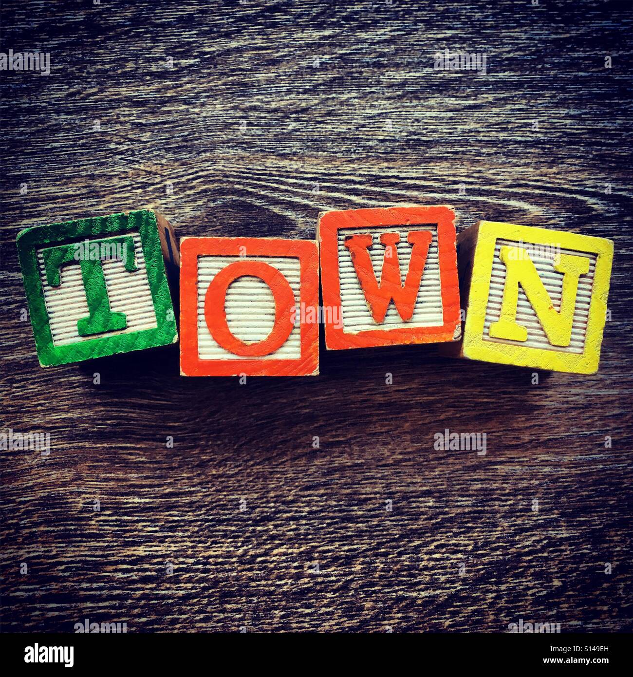 TOWN word written with wood block characters - Smartphone Captured Stock Image