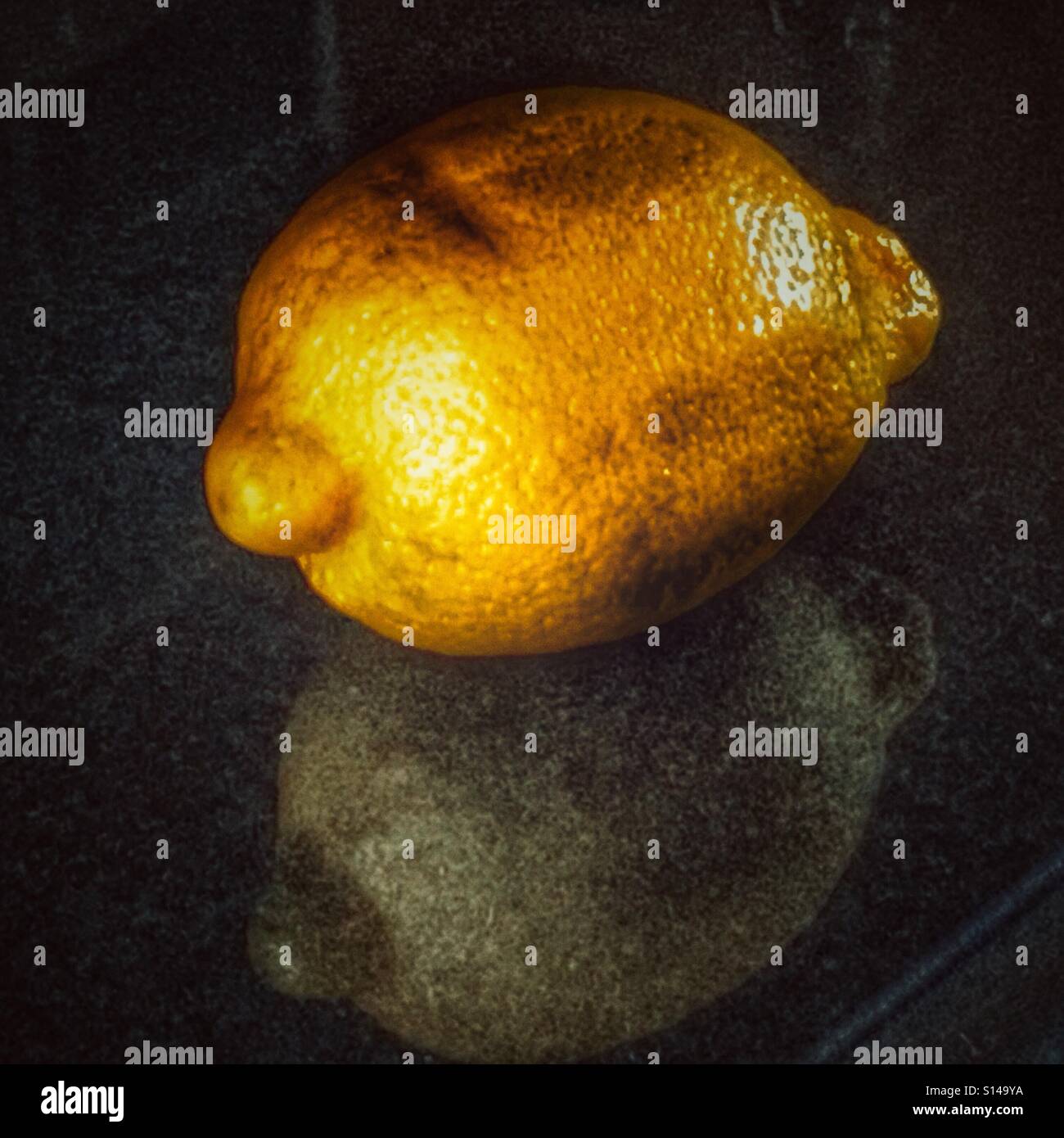Lemon on a polished granite kitchen counter - Smartphone Captured Stock Image