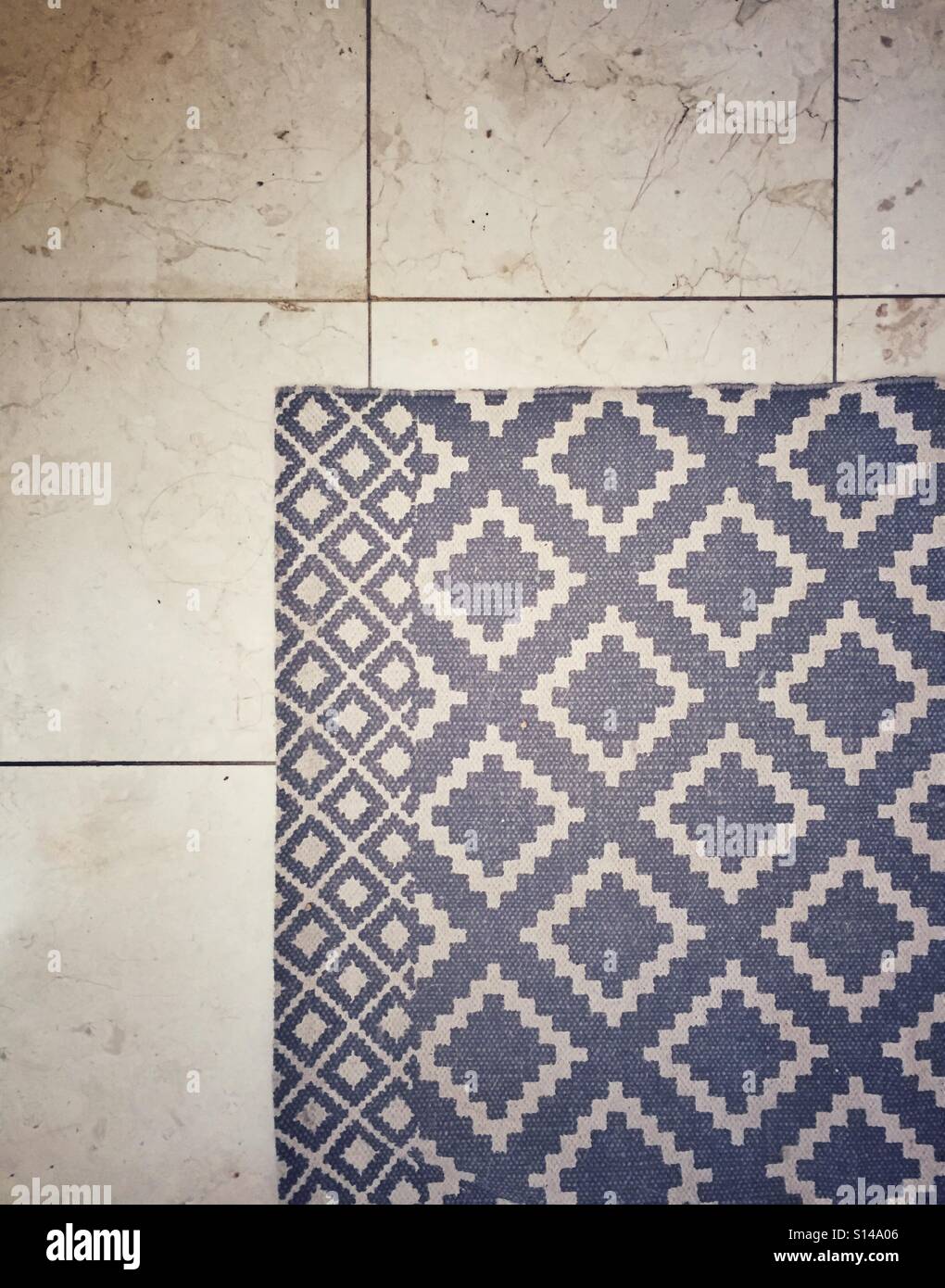 Rug on marble floor Stock Photo Alamy