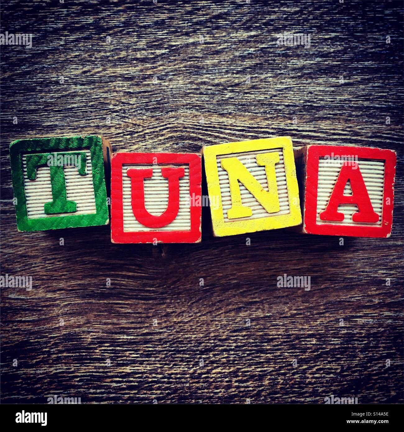 TUNA word written with wood block characters - Smartphone Captured Stock Image