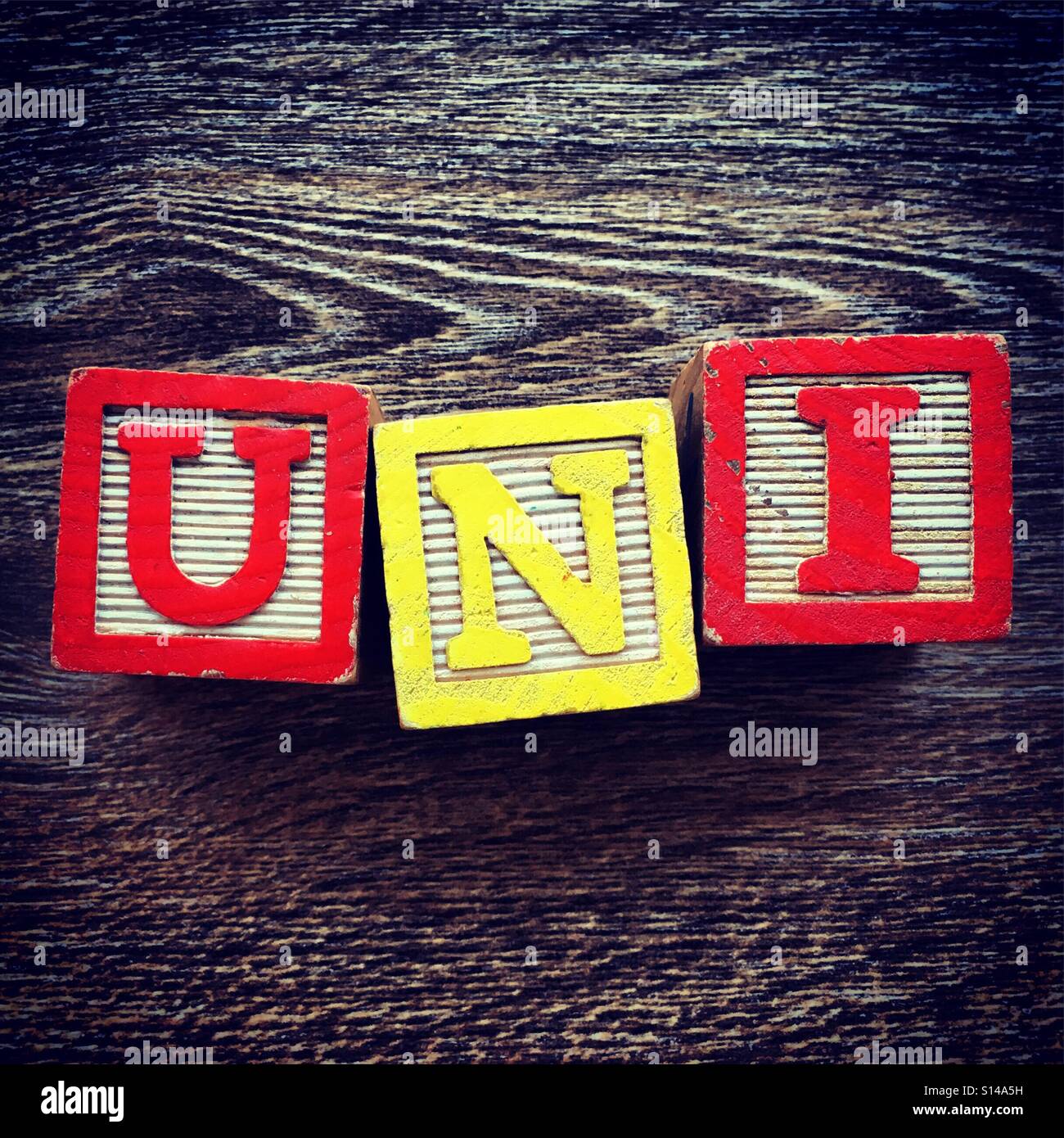 UNI word written with wood block characters - Smartphone Captured Stock Image