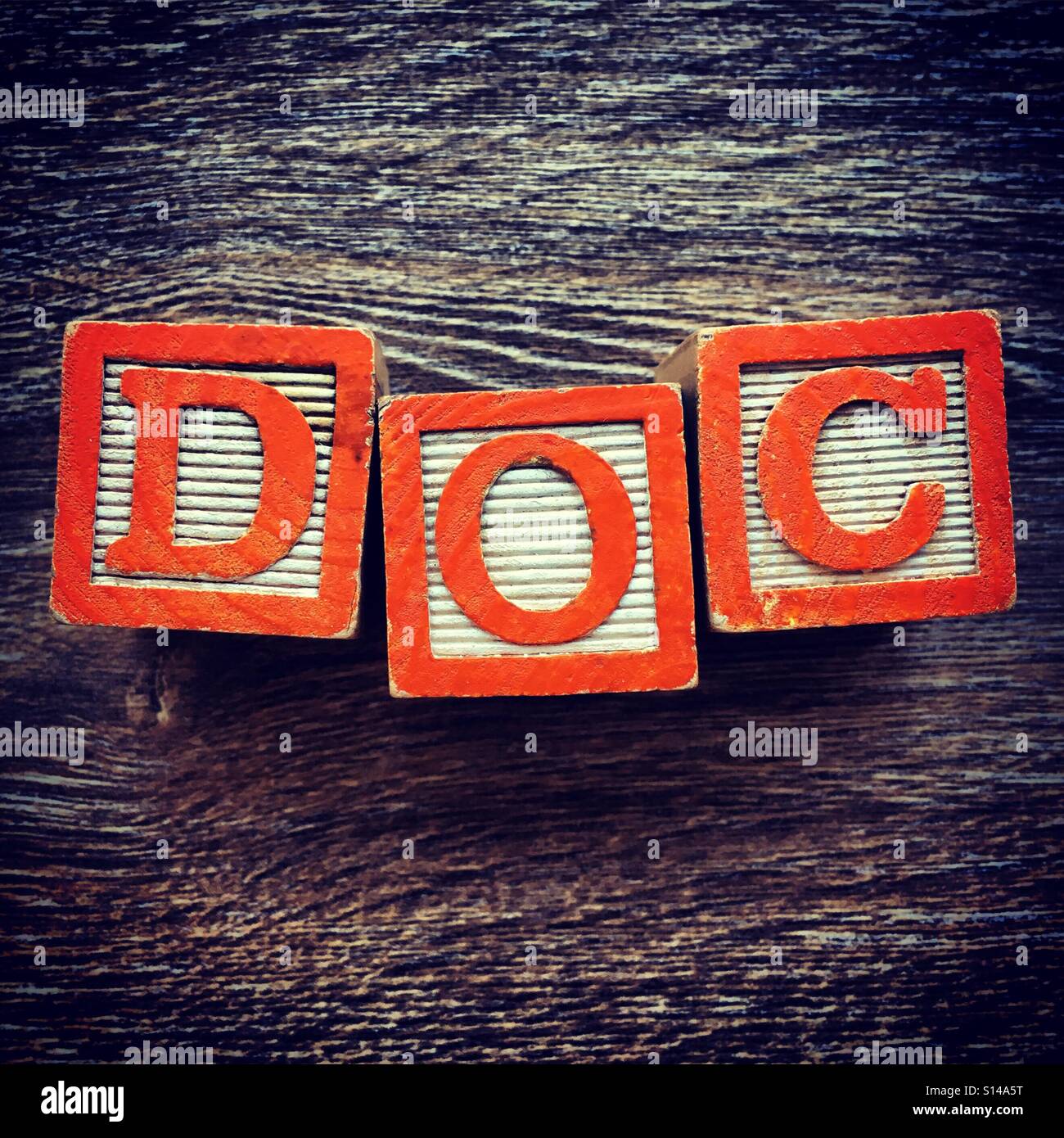 DOC word written with wood block characters - Smartphone Captured Stock Image