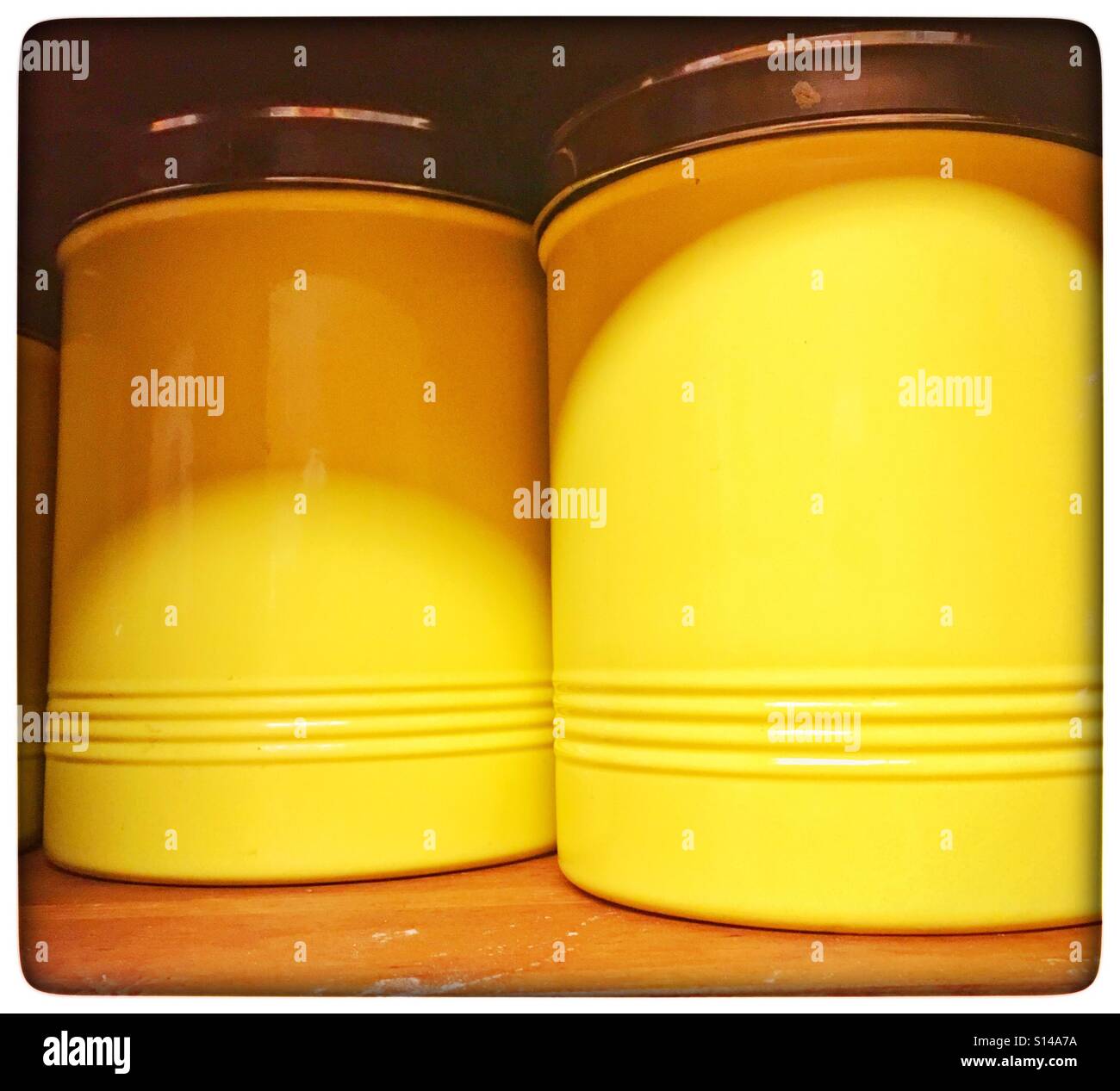 Yellow metal canisters Stock Photo Alamy