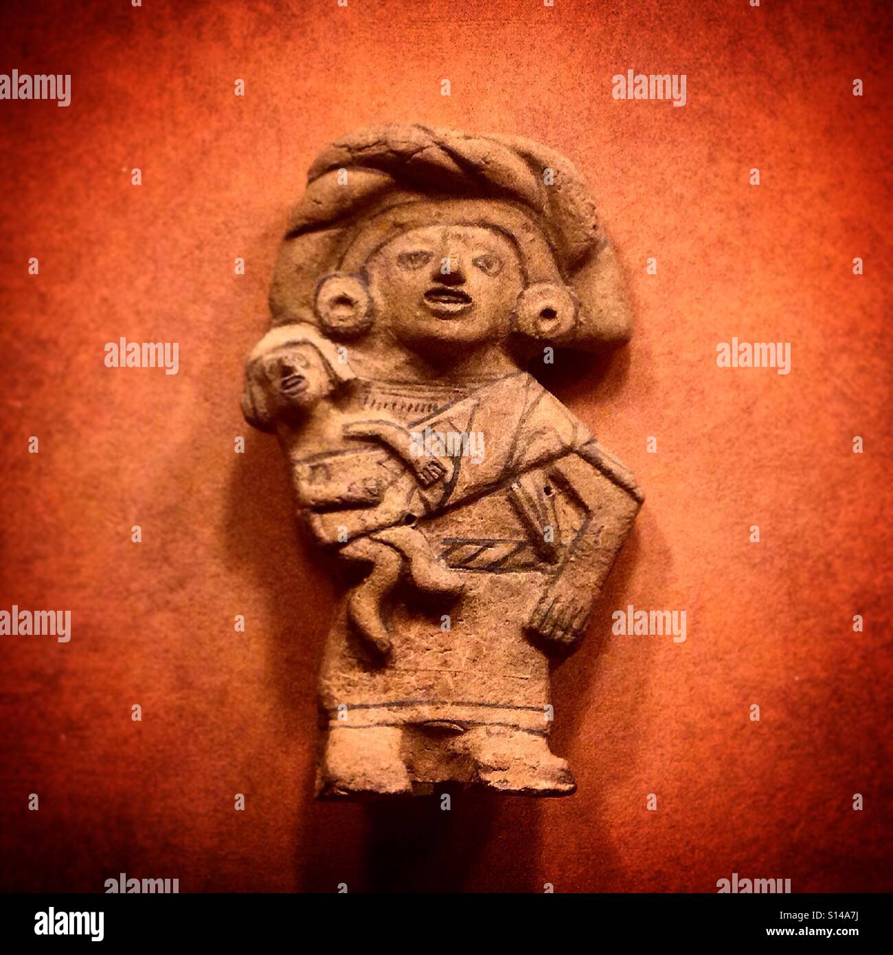 A Mesoamerican Pre-Hispanic sculpture of a woman carrying a child decorates  the Museo Nacional de Antropologia in Mexico City, Mexico Stock Photo