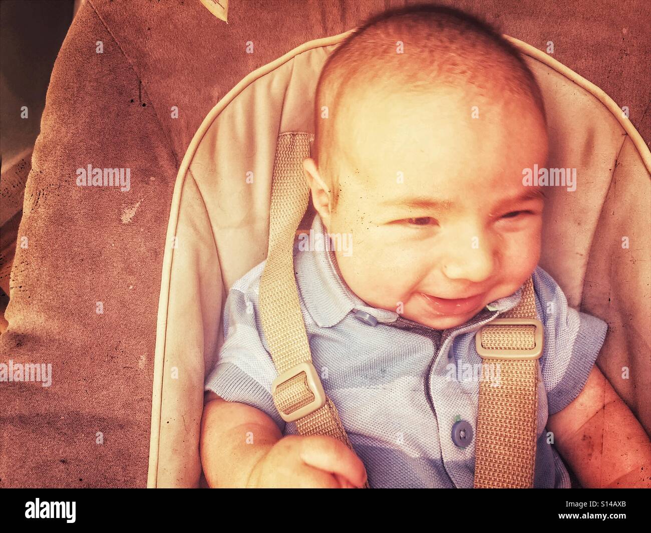 Baby boy smiling in swing, France - Smartphone Captured Stock Image