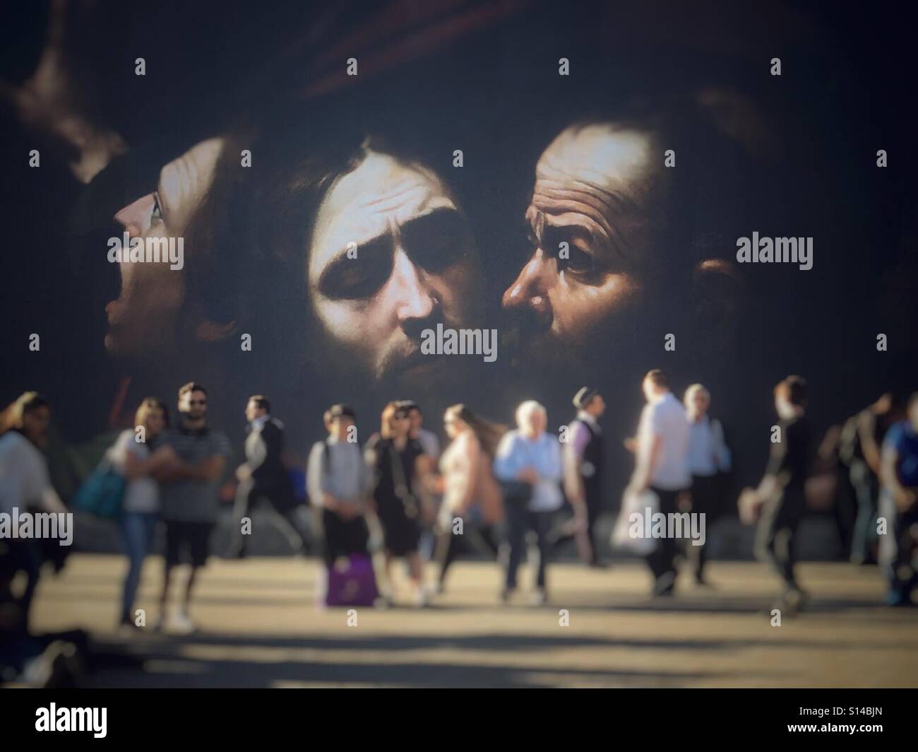 The Taking of Christ by Caravaggio displayed on a billboard in a pedestrian area outside the National Theatre, Trafalgar Square, London - Smartphone Captured Stock Image
