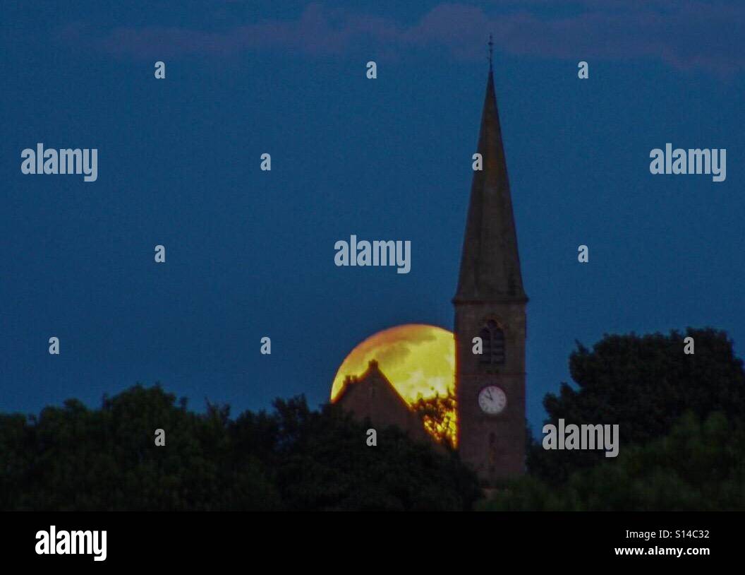 Harvest Moon rising behind Chryston Parish Church, North Lanarkshire, Scotland - Smartphone Captured Stock Image