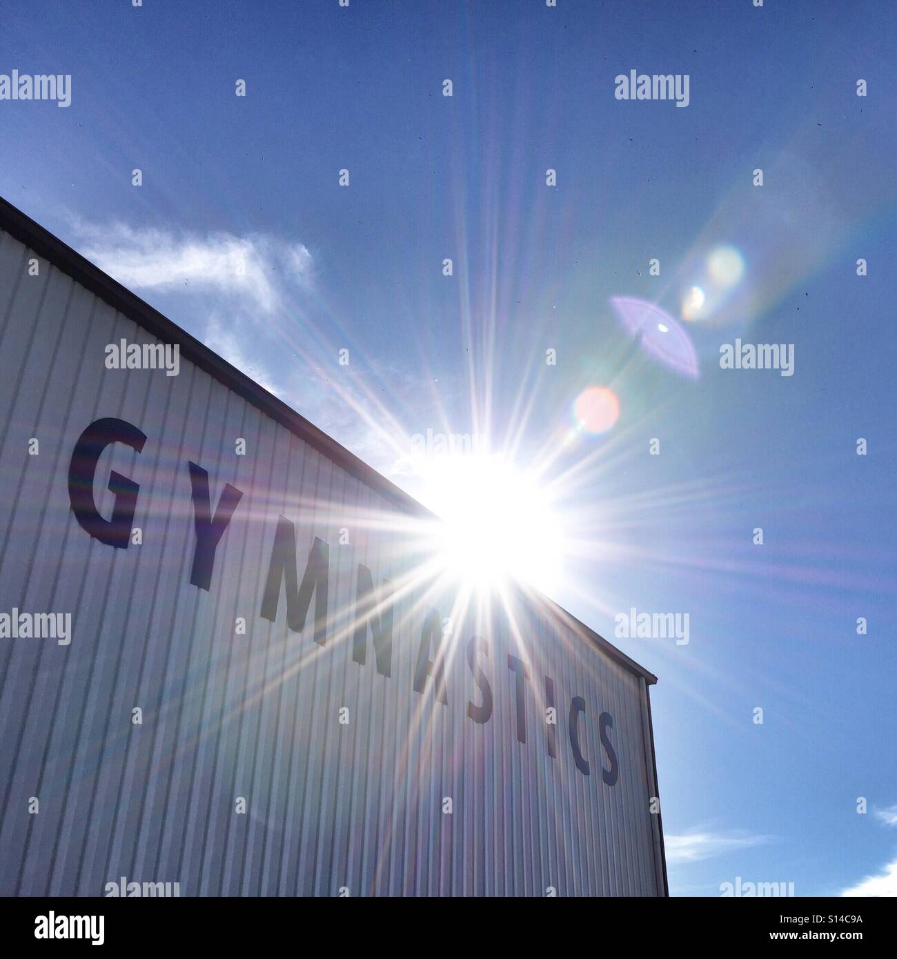 Gymnastics: a large sign on the side of a building. - Smartphone Captured Stock Image Gymnastics: a large sign on the side of a building. - Smartphone Captured Stock Image