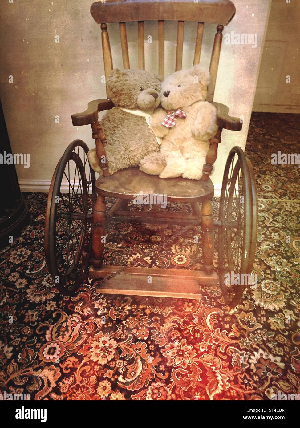 Old teddy bears on wooden wheelchair - Smartphone Captured Stock Image