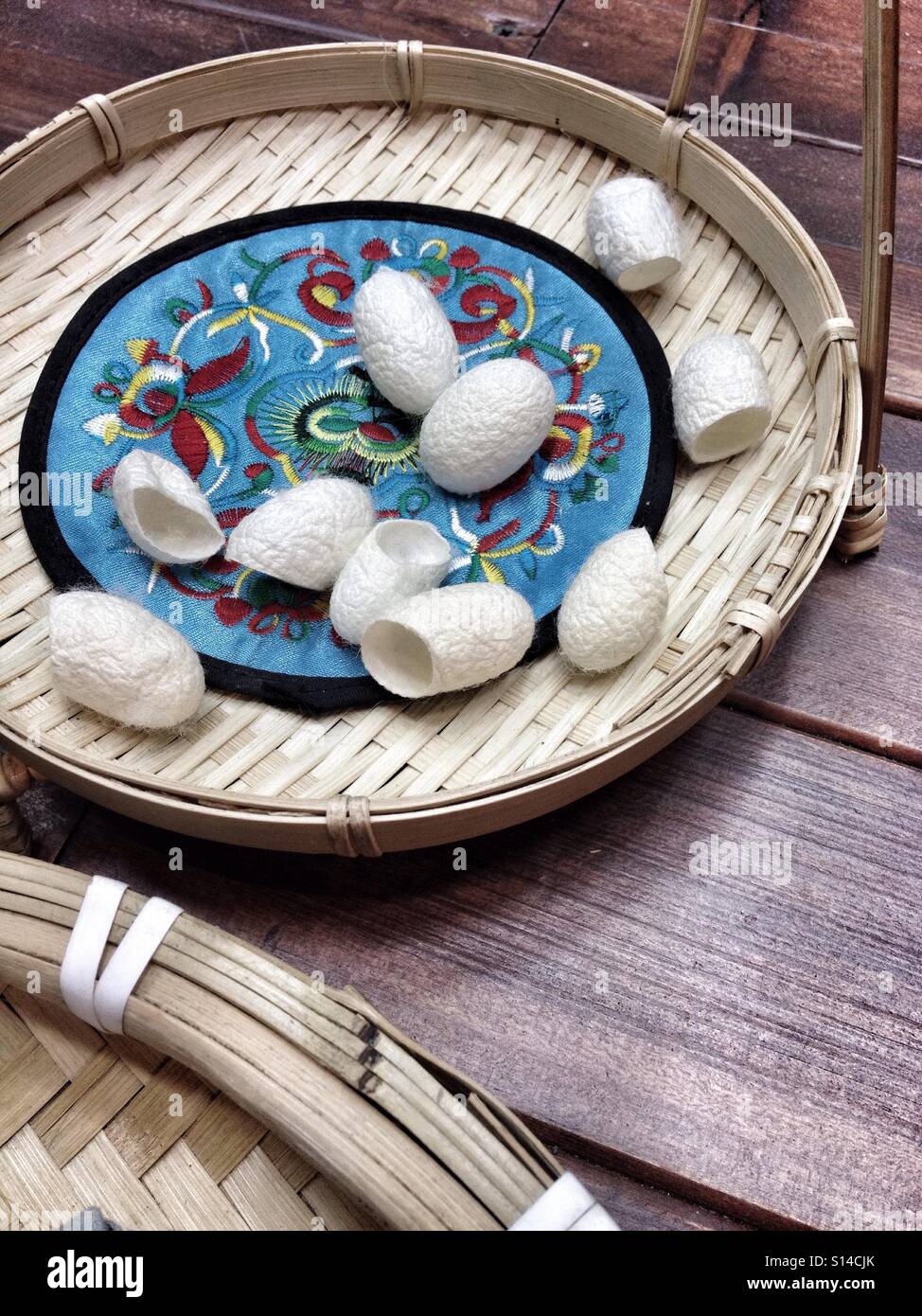 Silkworm Silk Cocoons On Bamboo Plate Waiting To Be Turned Into Silk Threading And Threads Stock Photo
