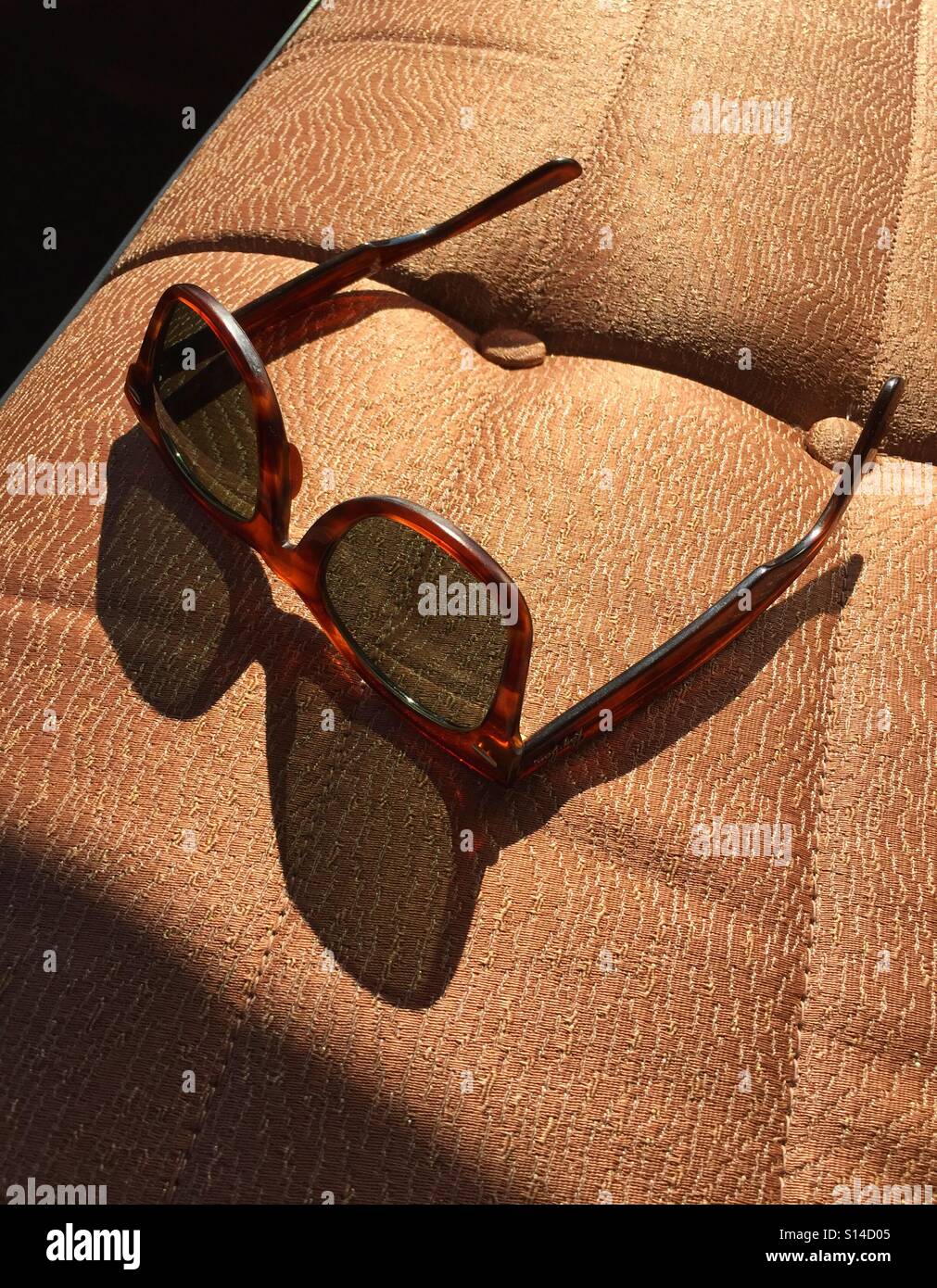 Sun shining through vintage shades on a classic car bench seat - Smartphone Captured Stock Image