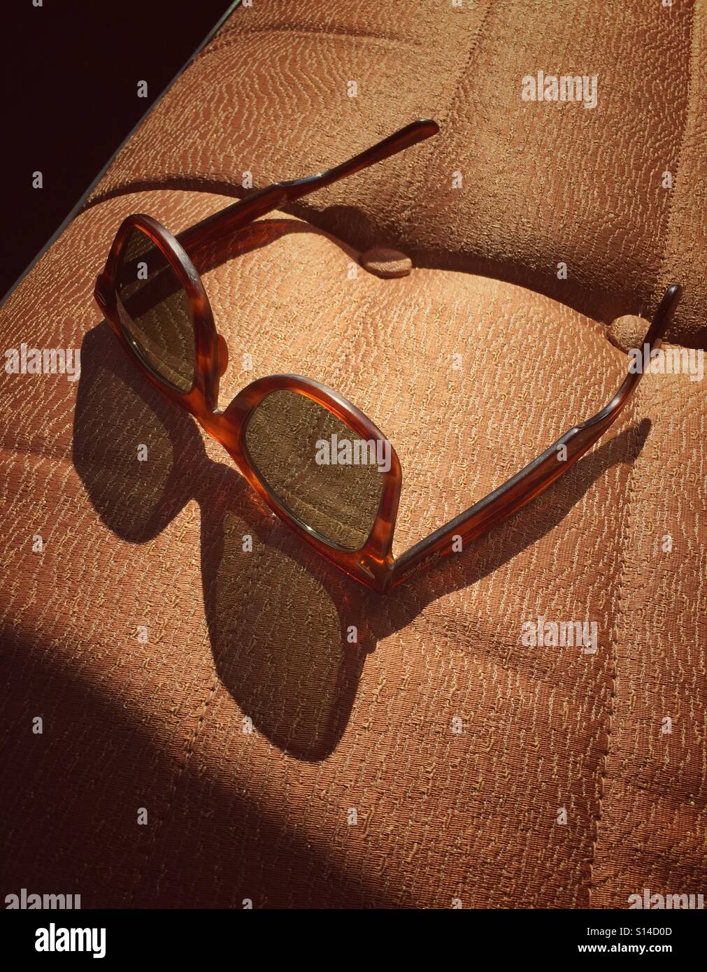 Sun shining through vintage shades on a classic car bench seat - Smartphone Captured Stock Image