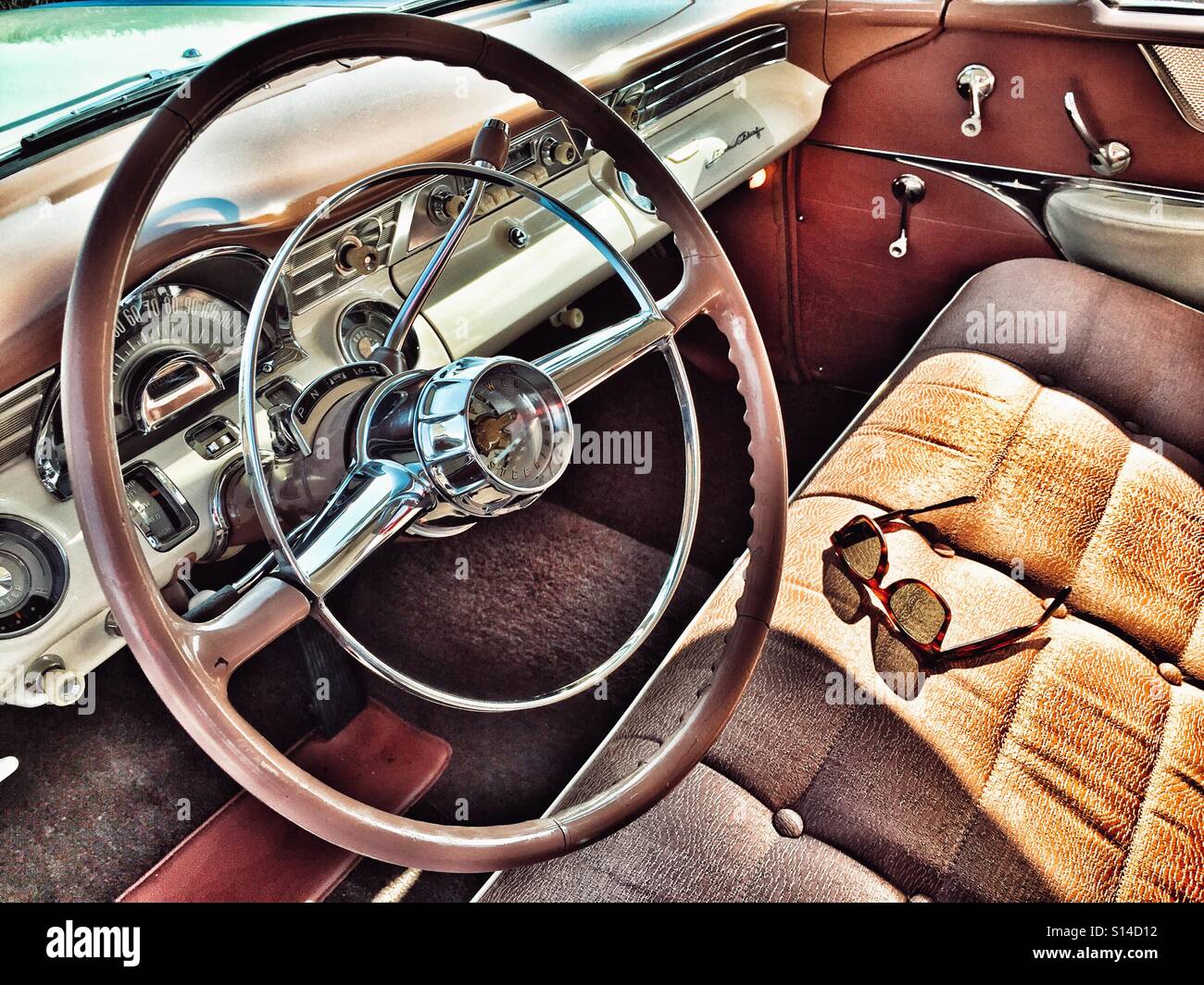 Sun shining through sunglasses casting a shadow on a classic American car bench seat - Smartphone Captured Stock Image