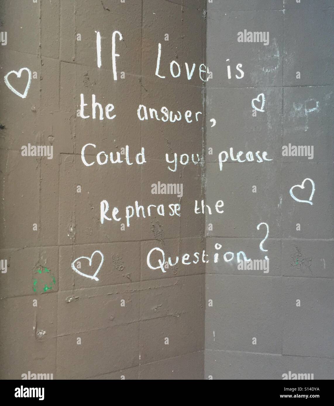 Graffiti chalked on a wall. 'If love is the answer... ' Stock Photo