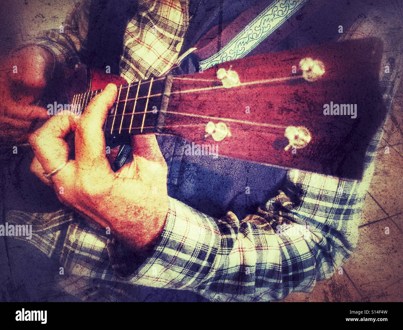 Woman playing a soprano ukulele, finger style - Smartphone Captured Stock Image
