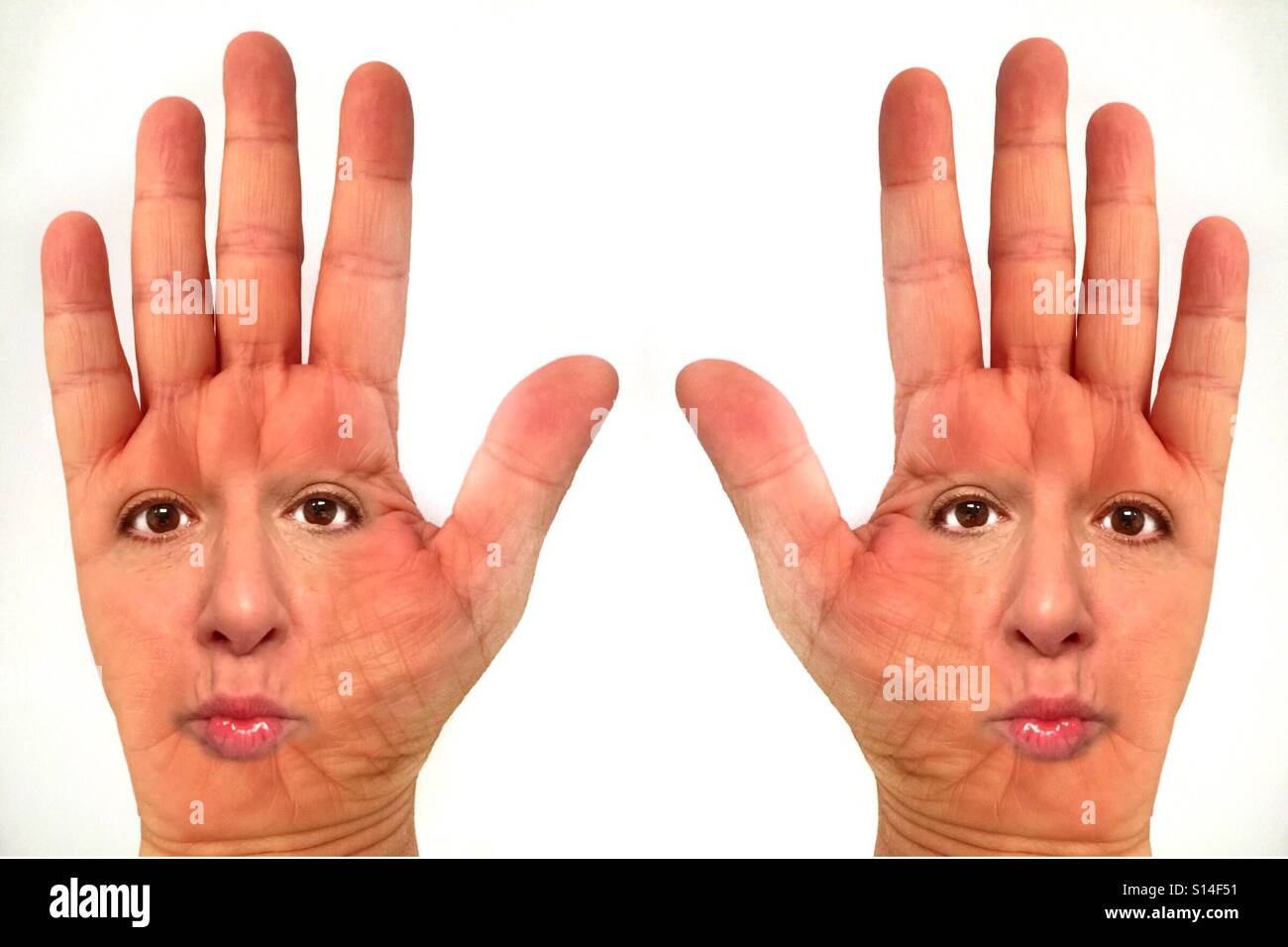An abstract image of two open hands, palms up, with a woman's face on the Palm - Smartphone Captured Stock Image