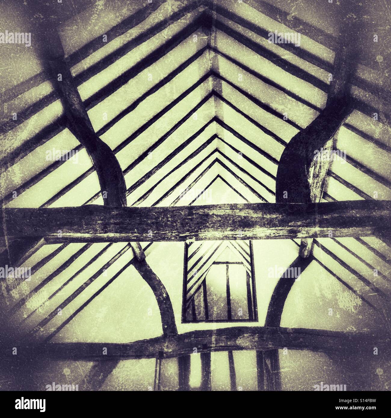 Ancient oak beams, supporting the roof of an old barn. - Smartphone Captured Stock Image