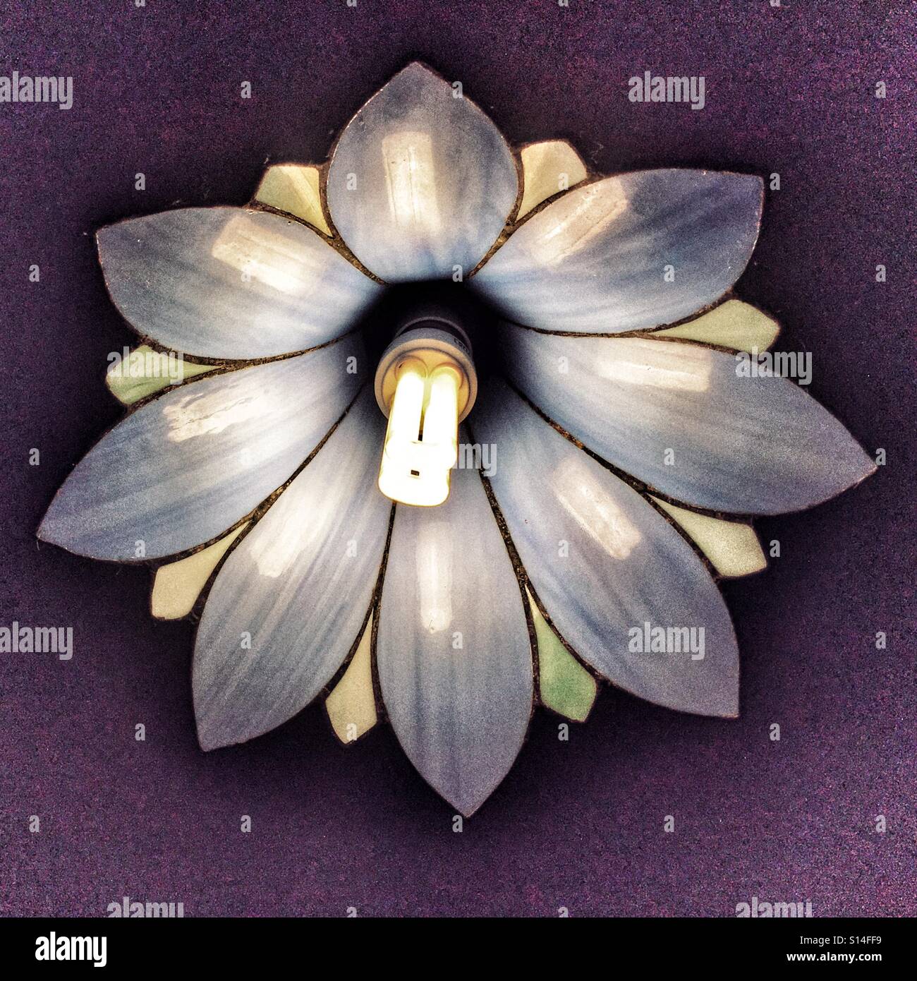 Ceiling light with glass lampshade and low energy bulb fitted. - Smartphone Captured Stock Image