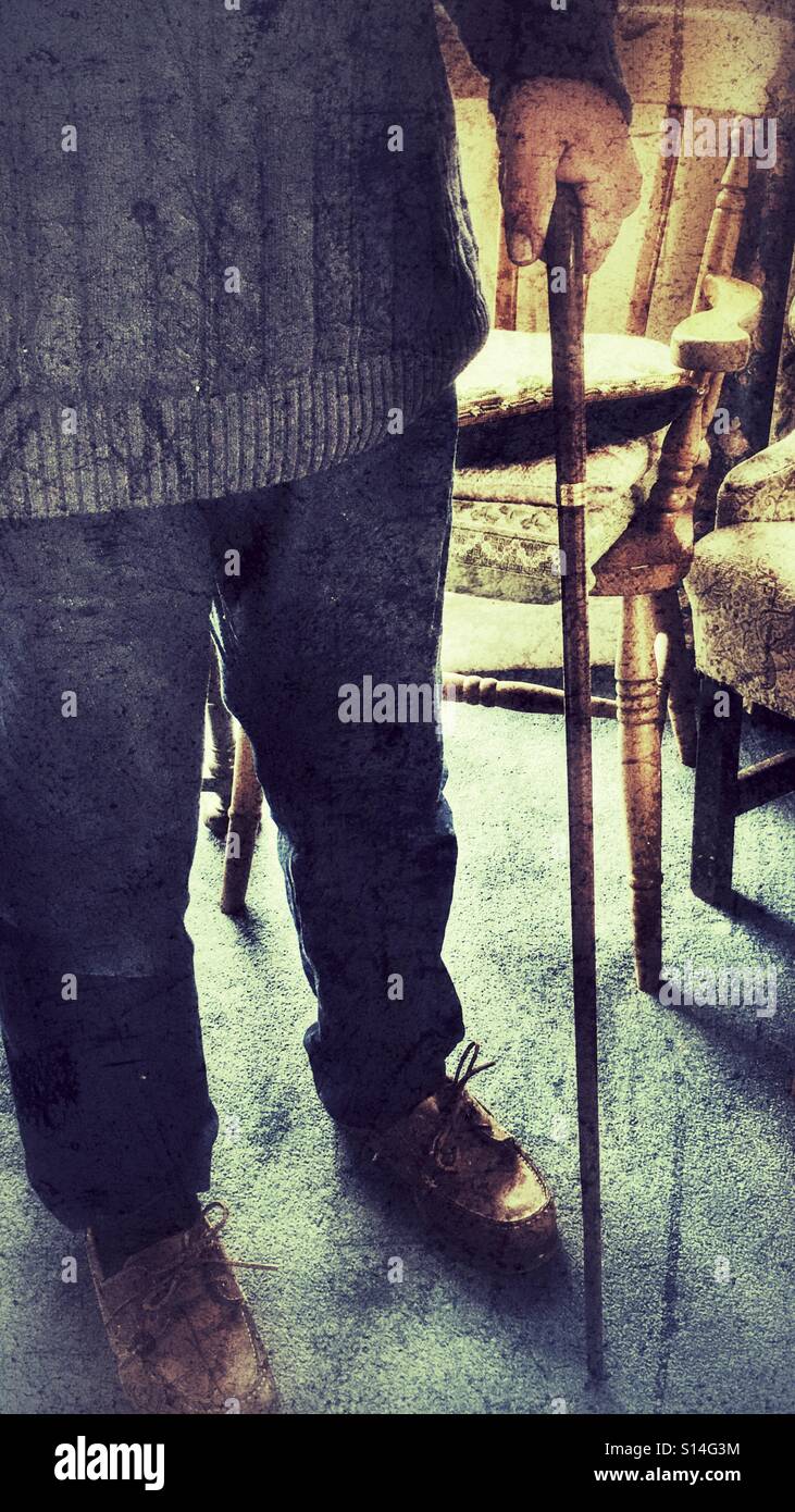 Pensioner standing, using walking stick - Smartphone Captured Stock Image