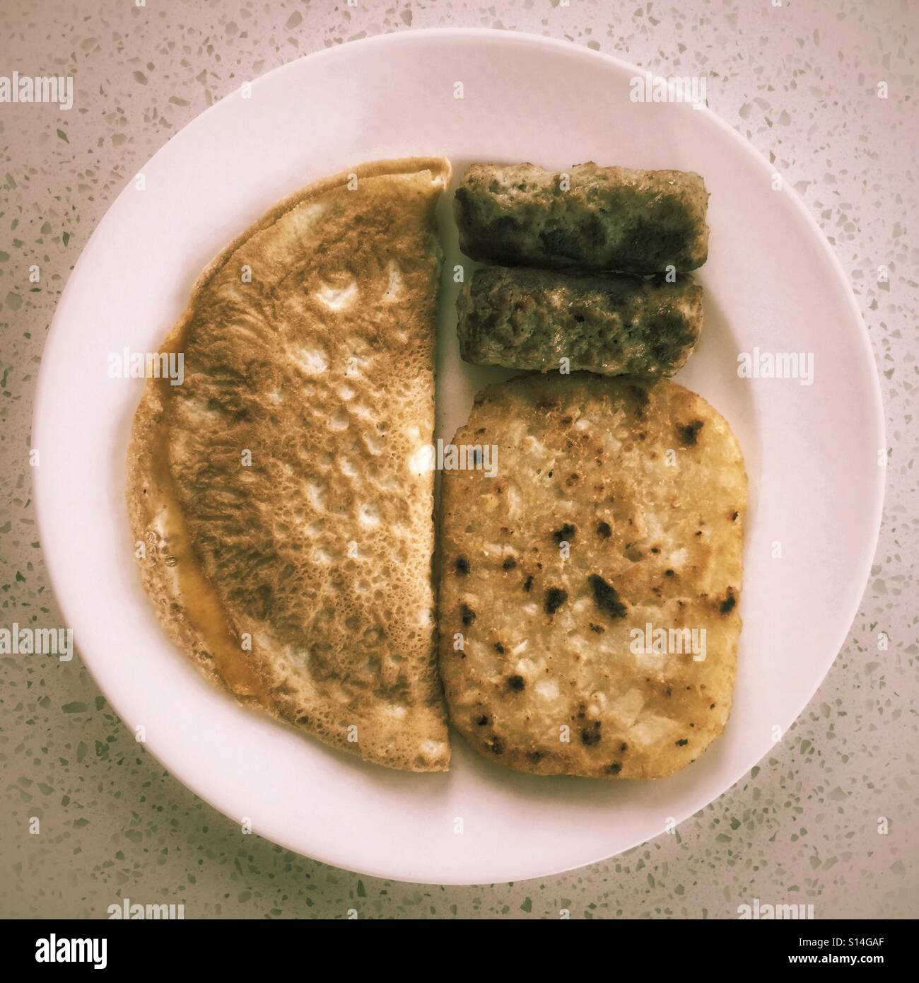 Cheese omelette, hashbrowns, and sausages for breakfast. - Smartphone Captured Stock Image