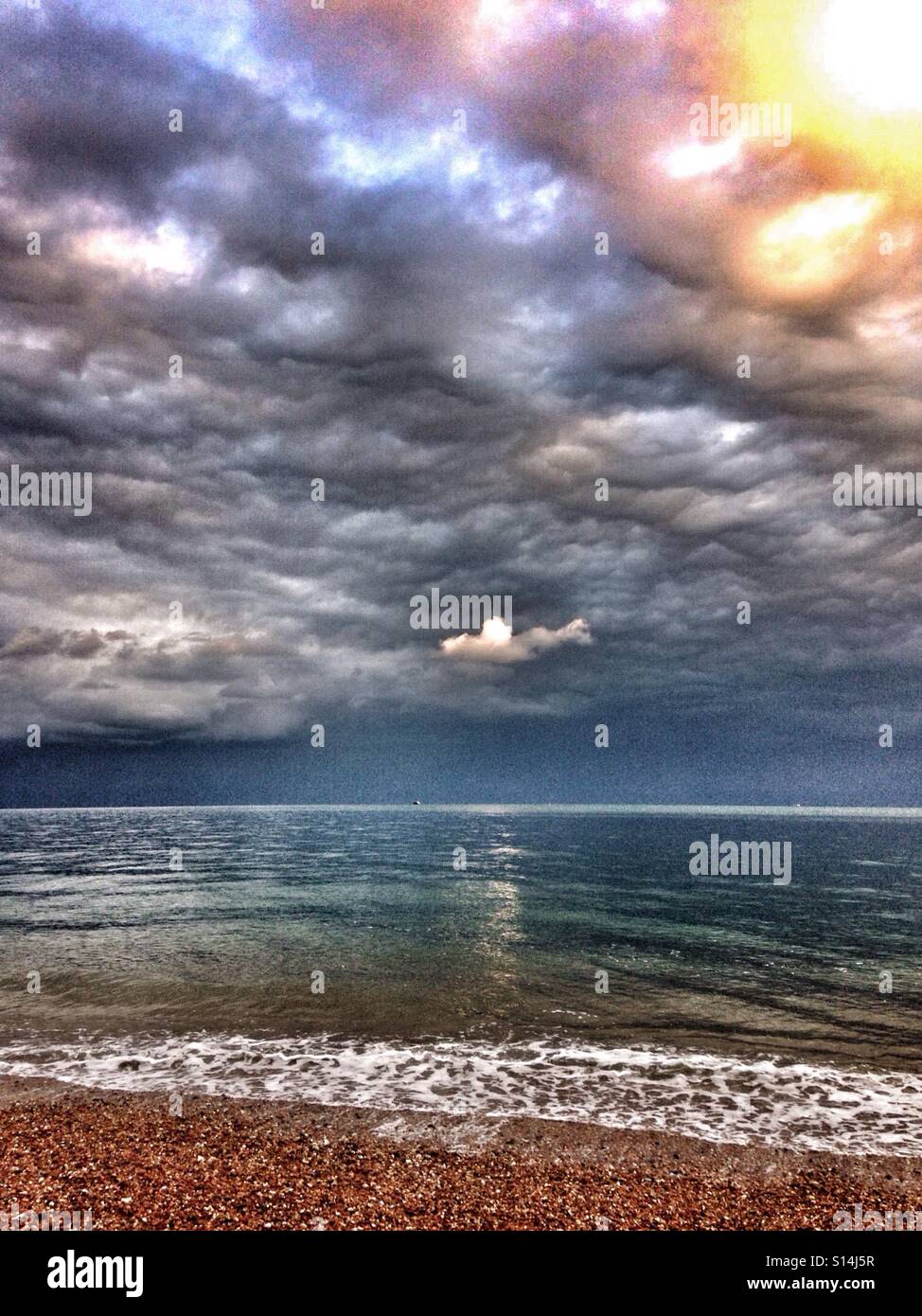 Light in the clouds above the sea - Smartphone Captured Stock Image