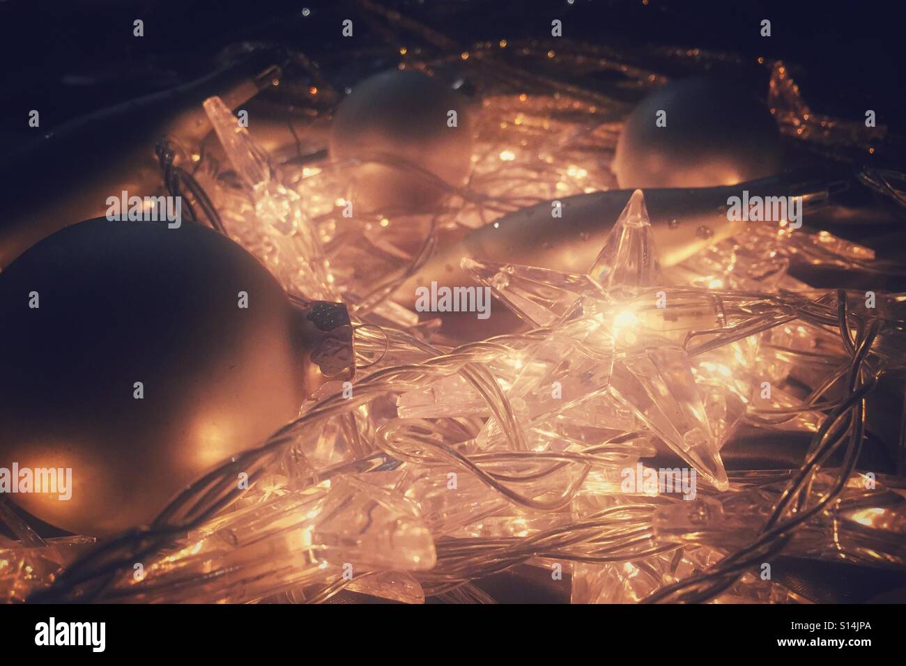 Close up view of Christmas lights and decorations bunched up on the ground - Smartphone Captured Stock Image